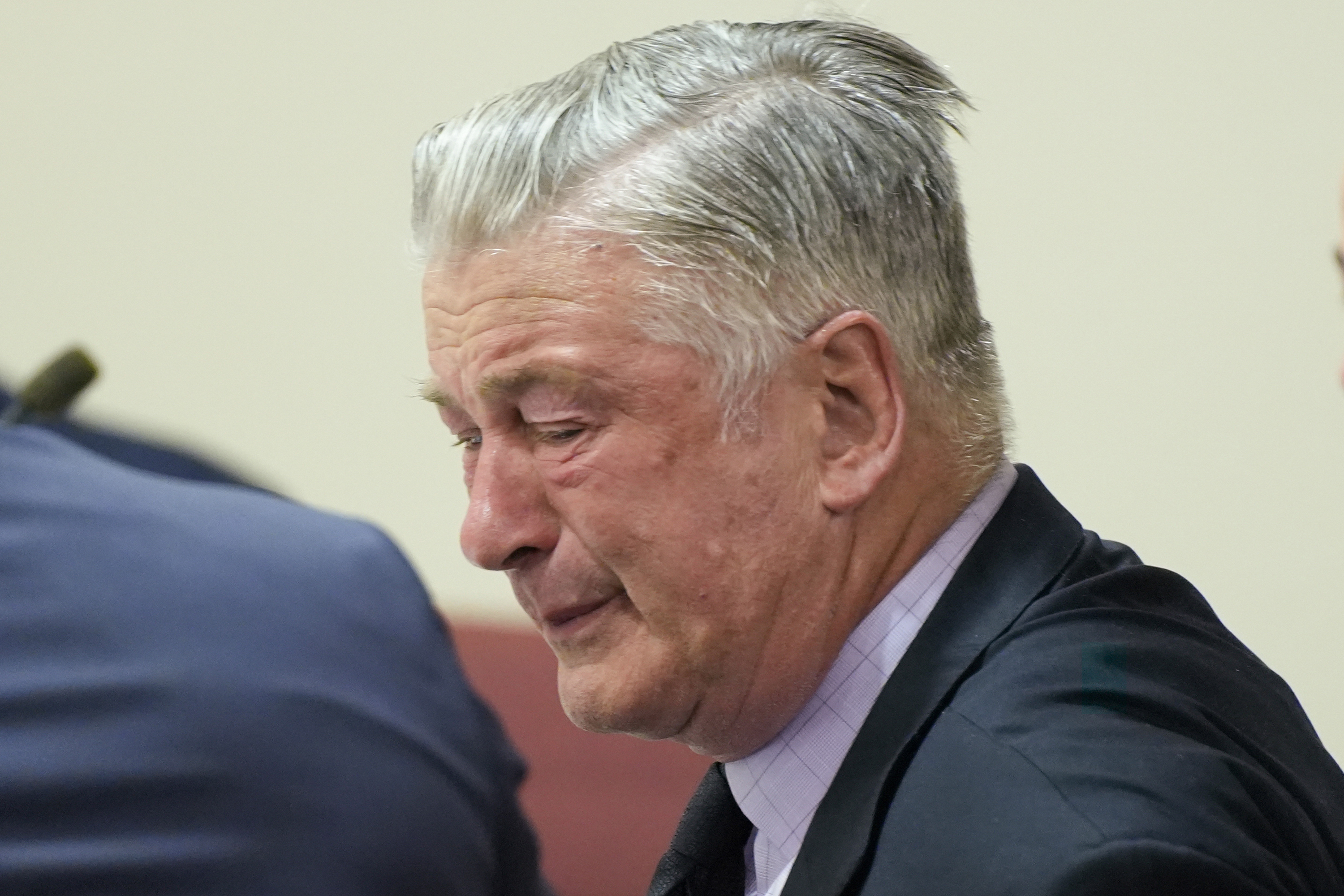 FILE - Actor Alec Baldwin, center, reacts as he sits between his attorneys Alex Spiro, left, and Luke Nikas after the judge threw out the involuntary manslaughter case for the 2021 fatal shooting of cinematographer Halyna Hutchins during filming of the Western movie "Rust," Friday, July 12, 2024, in Santa Fe, N.M. (Ramsay de Give/Pool Photo via AP, File)