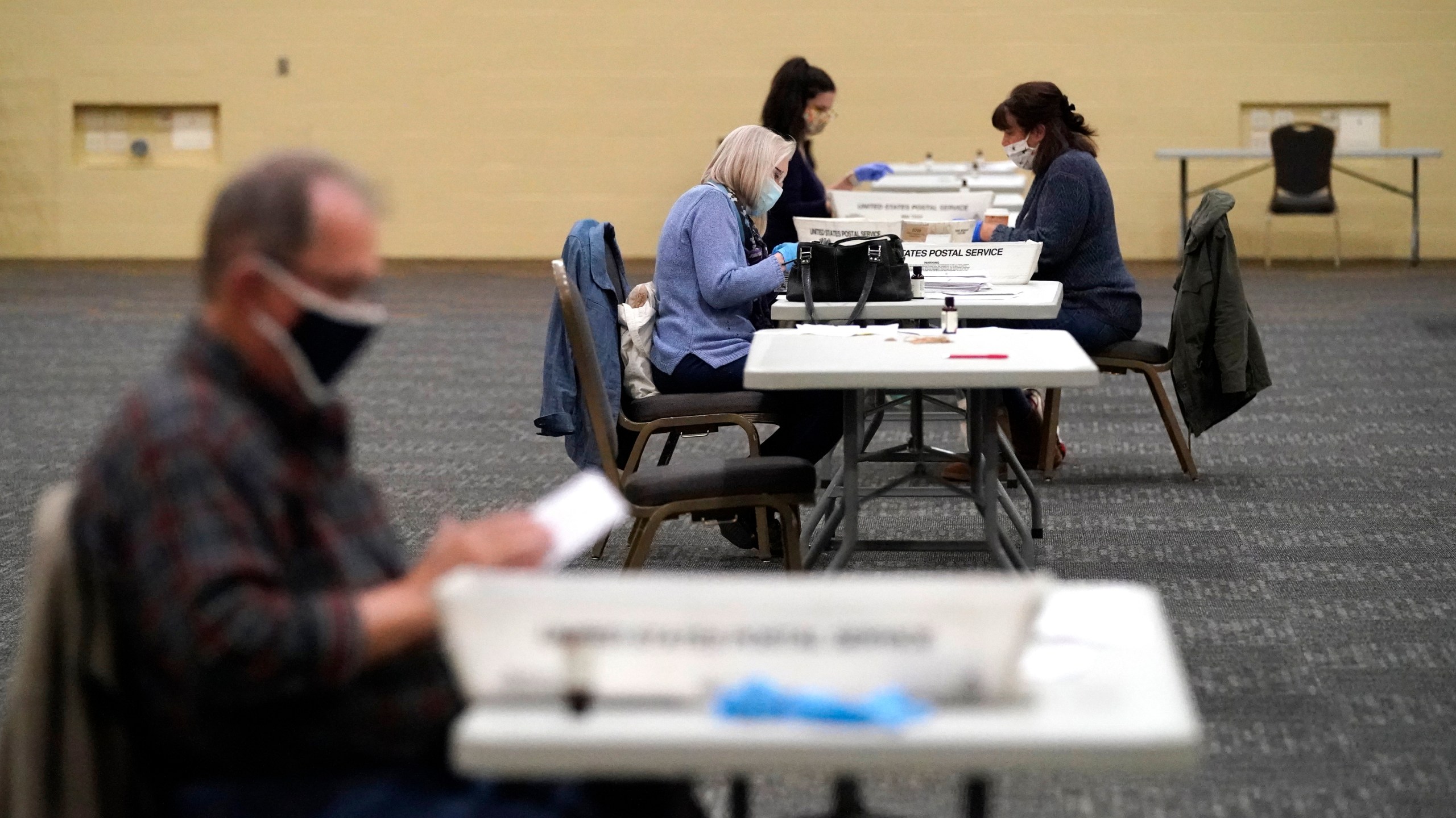 FILE - Workers prepare mail-in ballots for counting, Nov. 4, 2020, at the convention center in Lancaster, Pa. (AP Photo/Julio Cortez, File)