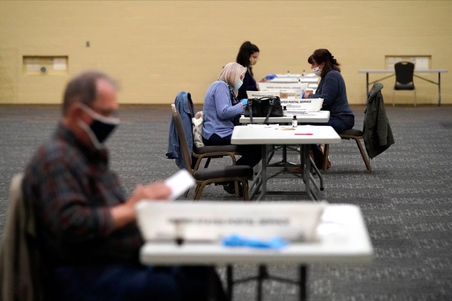 FILE - Workers prepare mail-in ballots for counting, Nov. 4, 2020, at the convention center in Lancaster, Pa. (AP Photo/Julio Cortez, File)