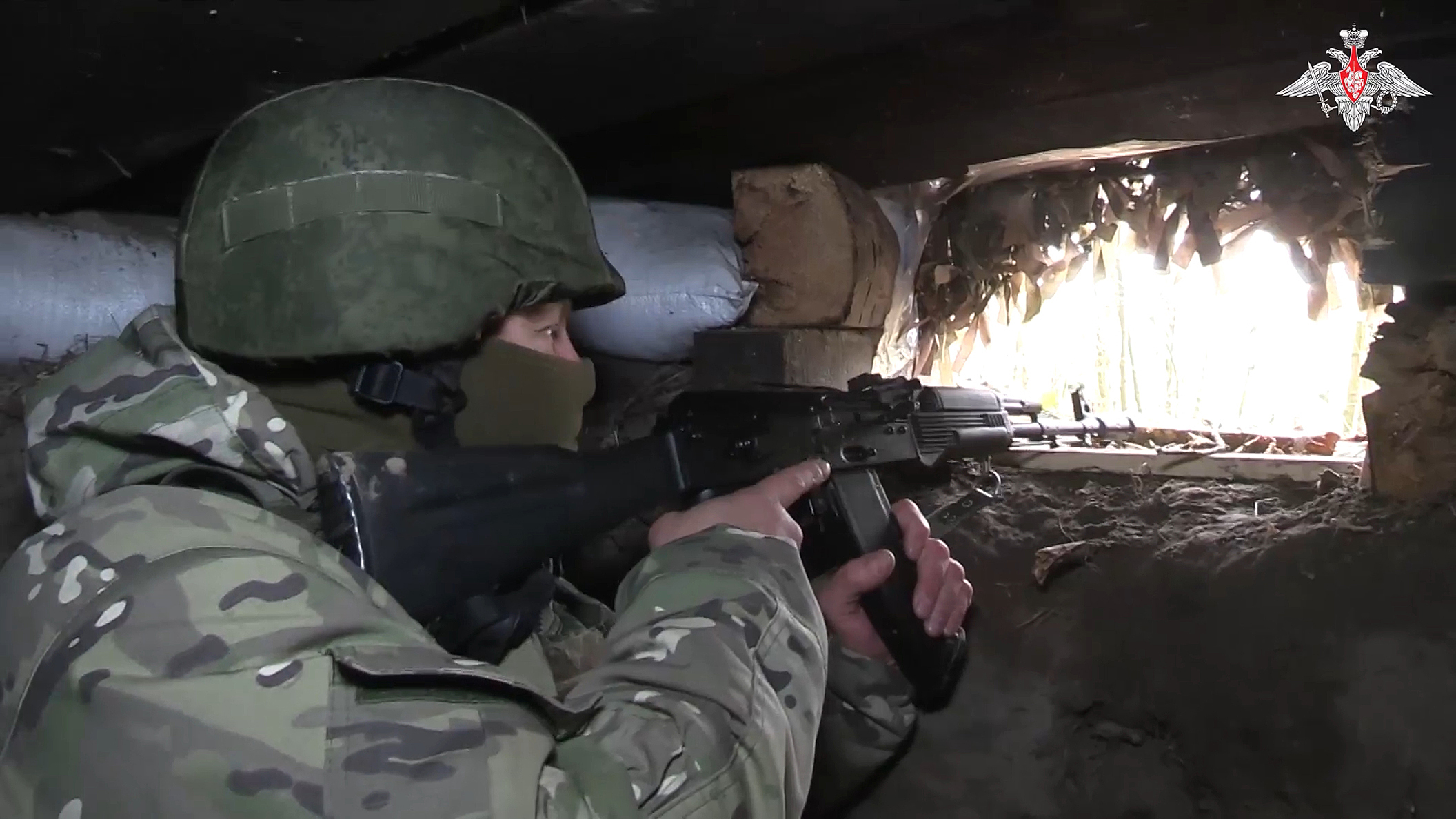 In this photo taken from video released by the Russian Defense Ministry on Thursday, Oct. 24, 2024, a Russian soldier aims from a bunker in the Russian - Ukrainian border area in the Kursk region, Russia. (Russian Defense Ministry Press Service photo via AP)