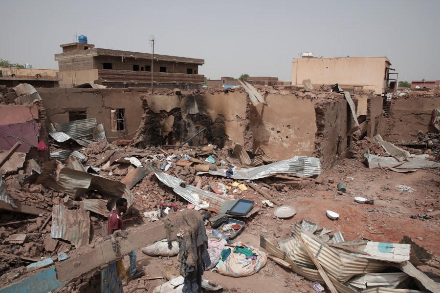 File - A man walks by a house hit in recent fighting in Khartoum, Sudan, an area torn by fighting between the military and the notorious paramilitary Rapid Support Forces, April 25, 2023. (AP Photo/Marwan Ali, File)