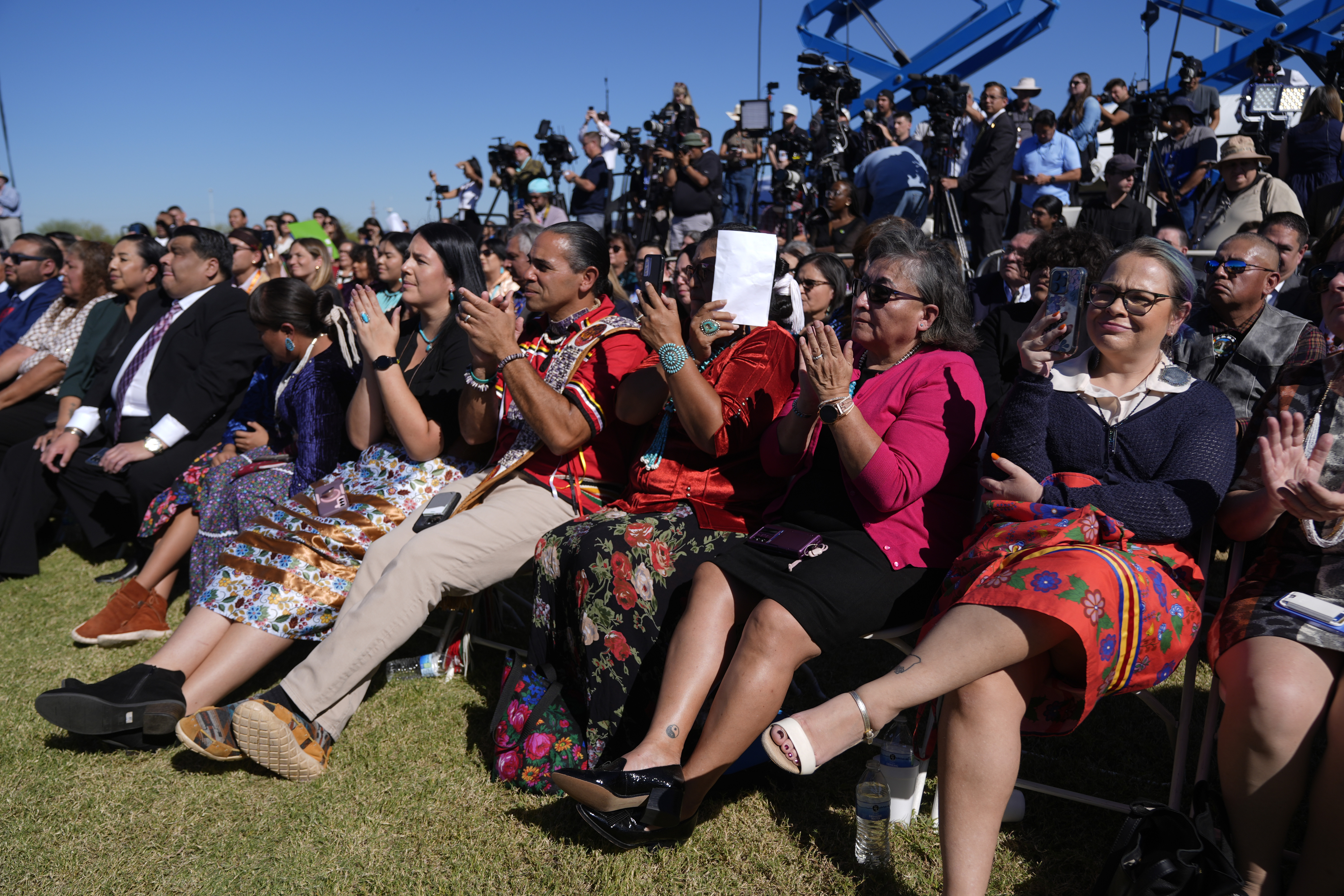 Attendees listen as Interior Secretary Deb Haaland speaks before President Joe Biden at the Gila Crossing Community School in the Gila River Indian Community reservation in Laveen, Ariz., Friday, Oct. 25, 2024. (AP Photo/Manuel Balce Ceneta)