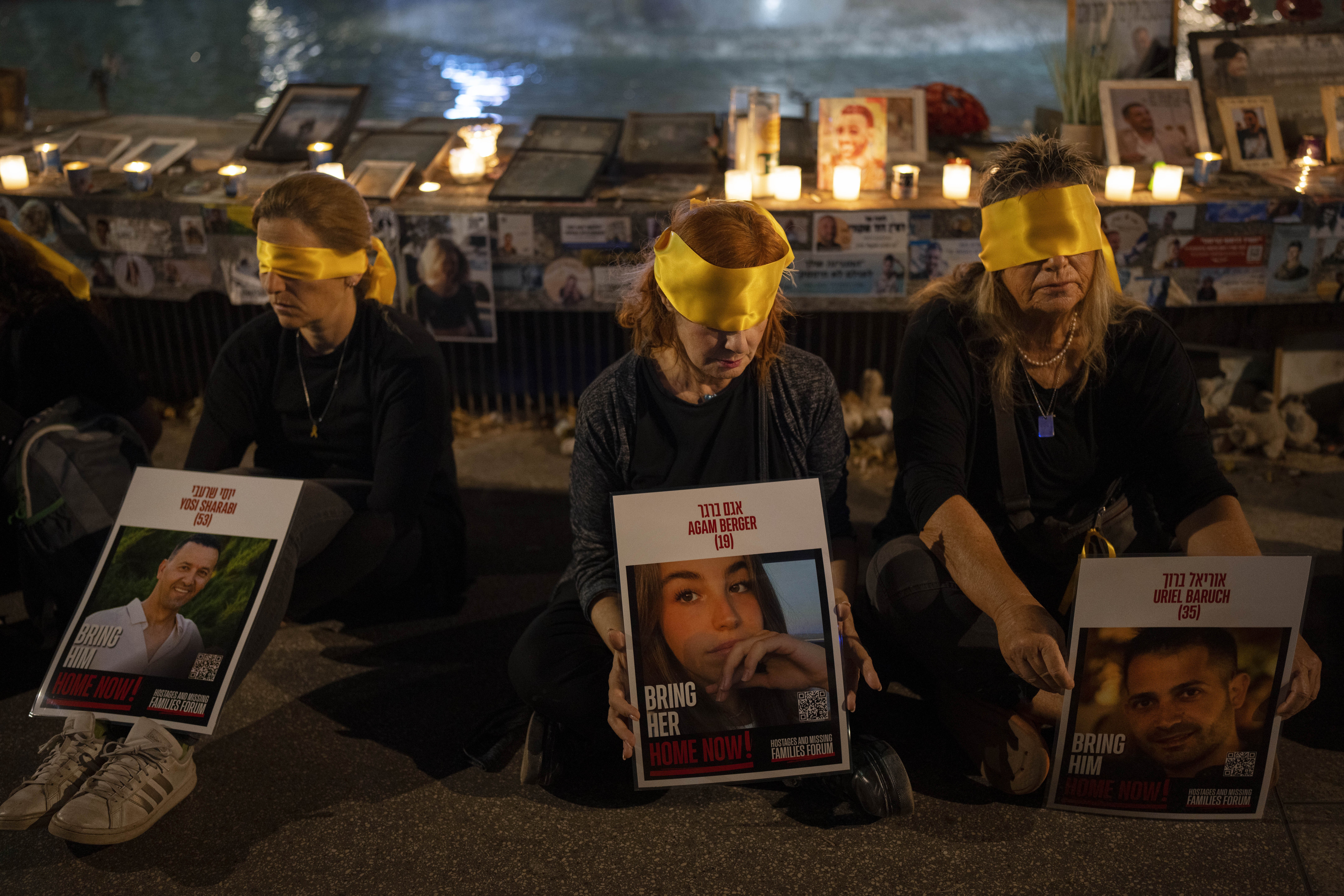 Activists sit blindfolded to mark one year in the Hebrew calendar since the Hamas cross-border attack on Israel in a protest against the celebration of the Jewish holiday of Simchat Torah while hostages are still held in Gaza, in Tel Aviv, Israel, Thursday, Oct. 24, 2024. (AP Photo/Oded Balilty)