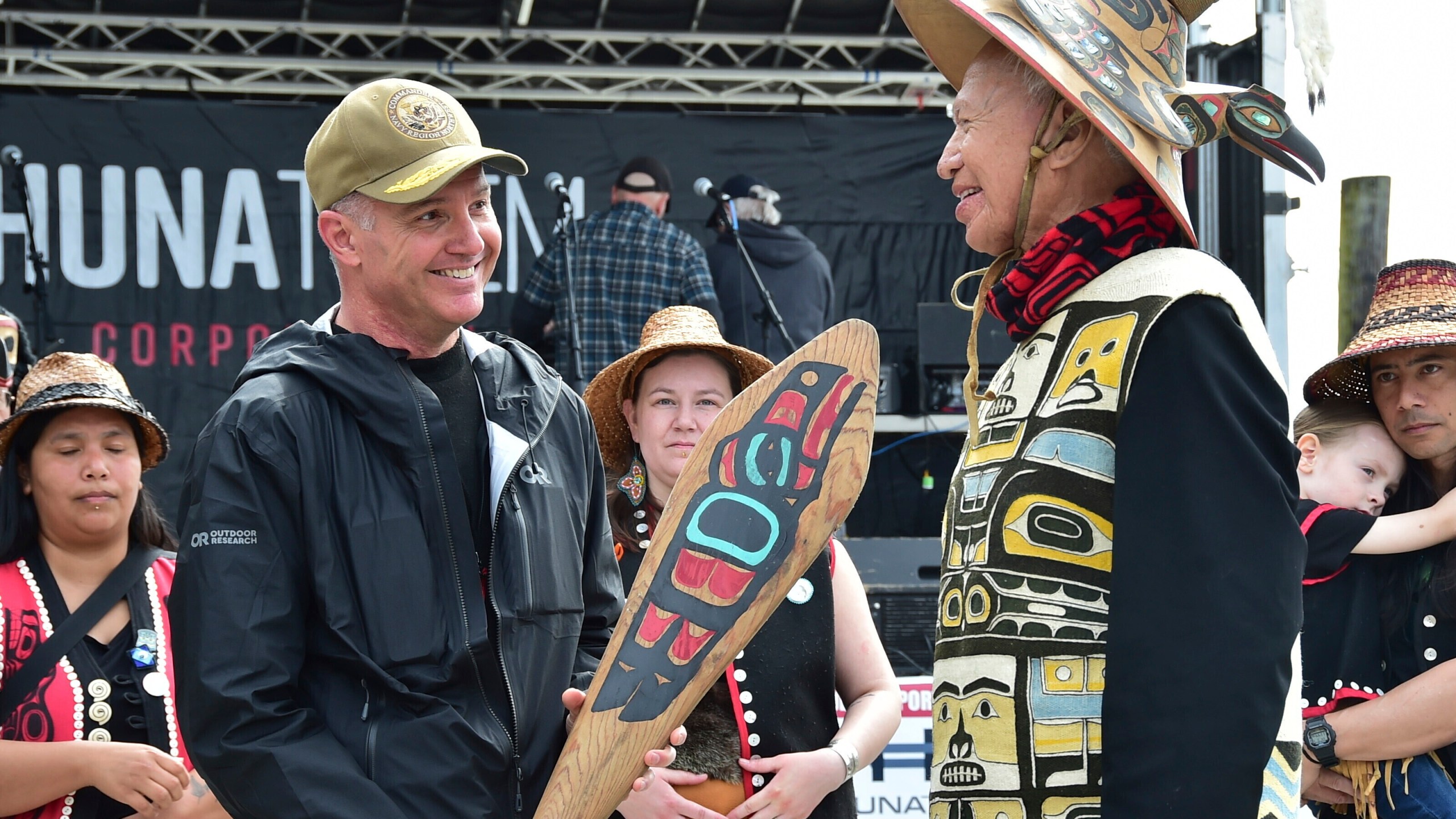 In this photo provided by the U.S. Navy, Commander of Navy Region Northwest Rear Adm. Mark Sucato is gifted a canoe paddle by Leonard John, Raven Clan, Native Village of Angoon, following the One People Canoe Society's welcoming ceremony to kick off the annual Juneau Maritime Festival on May 4, 2024, in Juneau, Alaska. (Chief Mass Communication Spc. Gretchen Albrecht/U.S. Navy via AP)