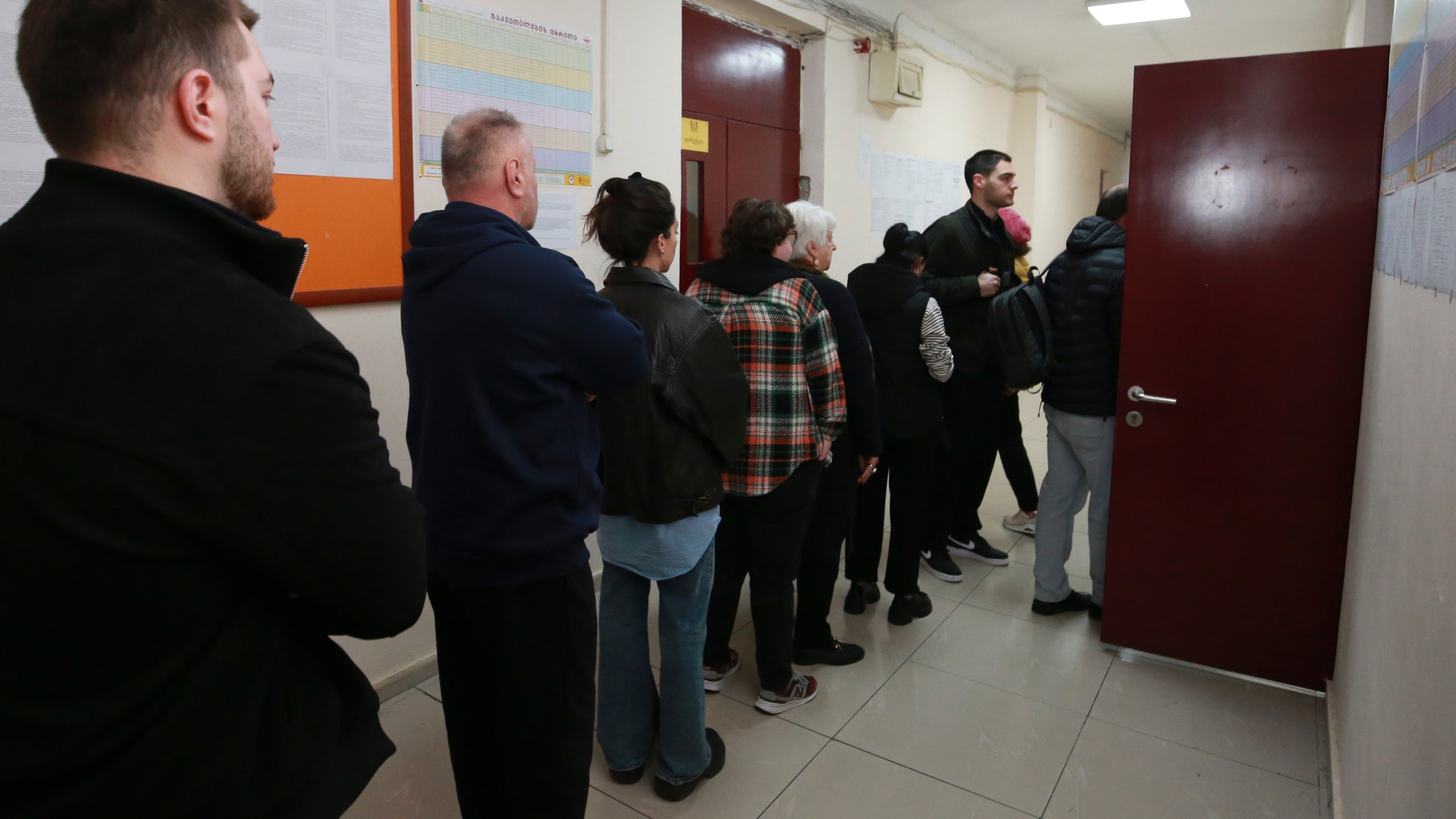 People queue to vote at a polling station during the parliamentary election in Tbilisi, Georgia, Saturday, Oct. 26, 2024. (AP Photo/Zurab Tsertsvadze)