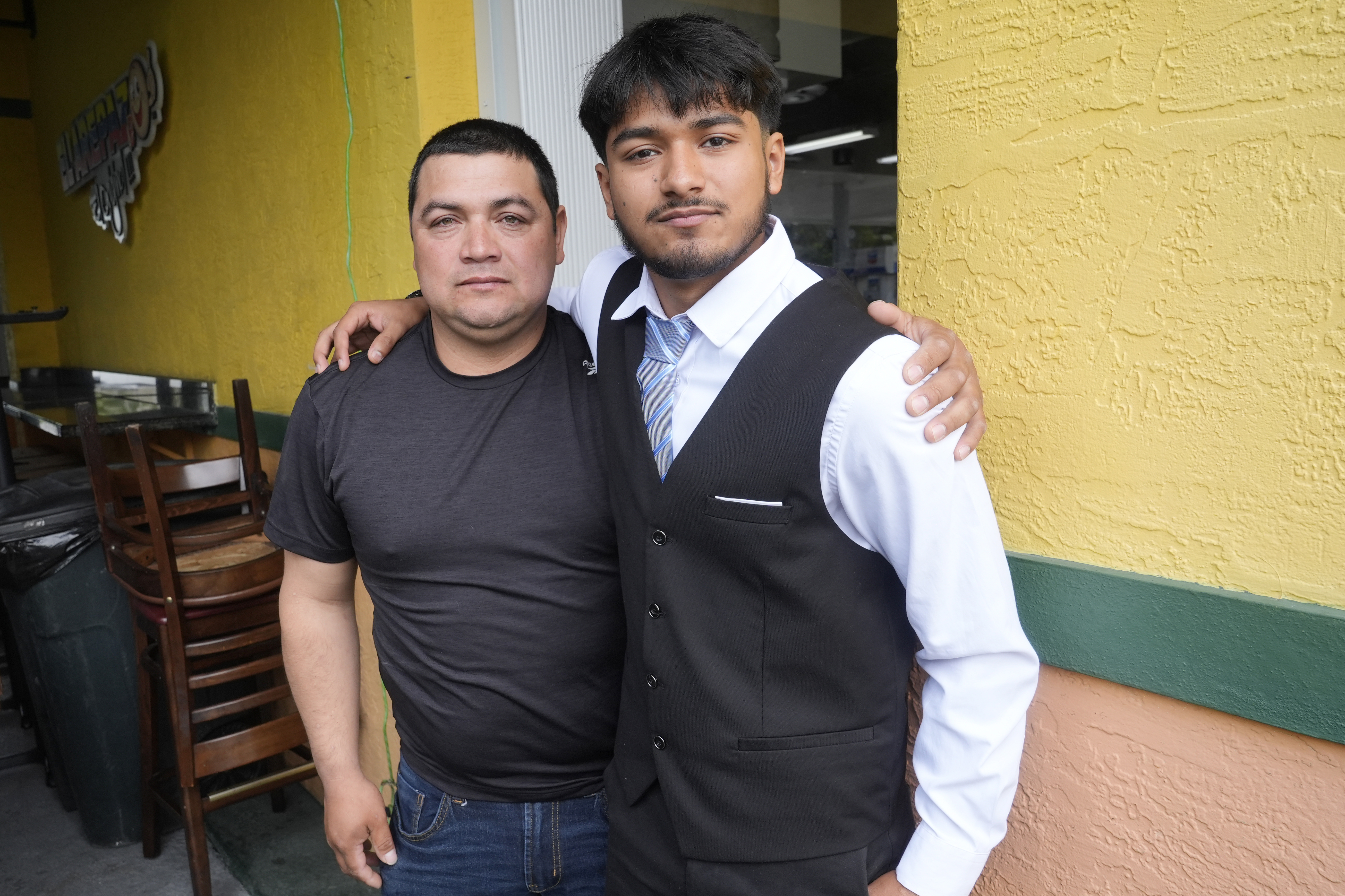 FILE - Billy and his father, no last name given, pause after speaking at a Democratic Party campaign event about their experience of being separated at the U.S.- Mexico border during the Trump administration, Oct. 16, 2024, in Doral, Fla. (AP Photo/Marta Lavandier, File)