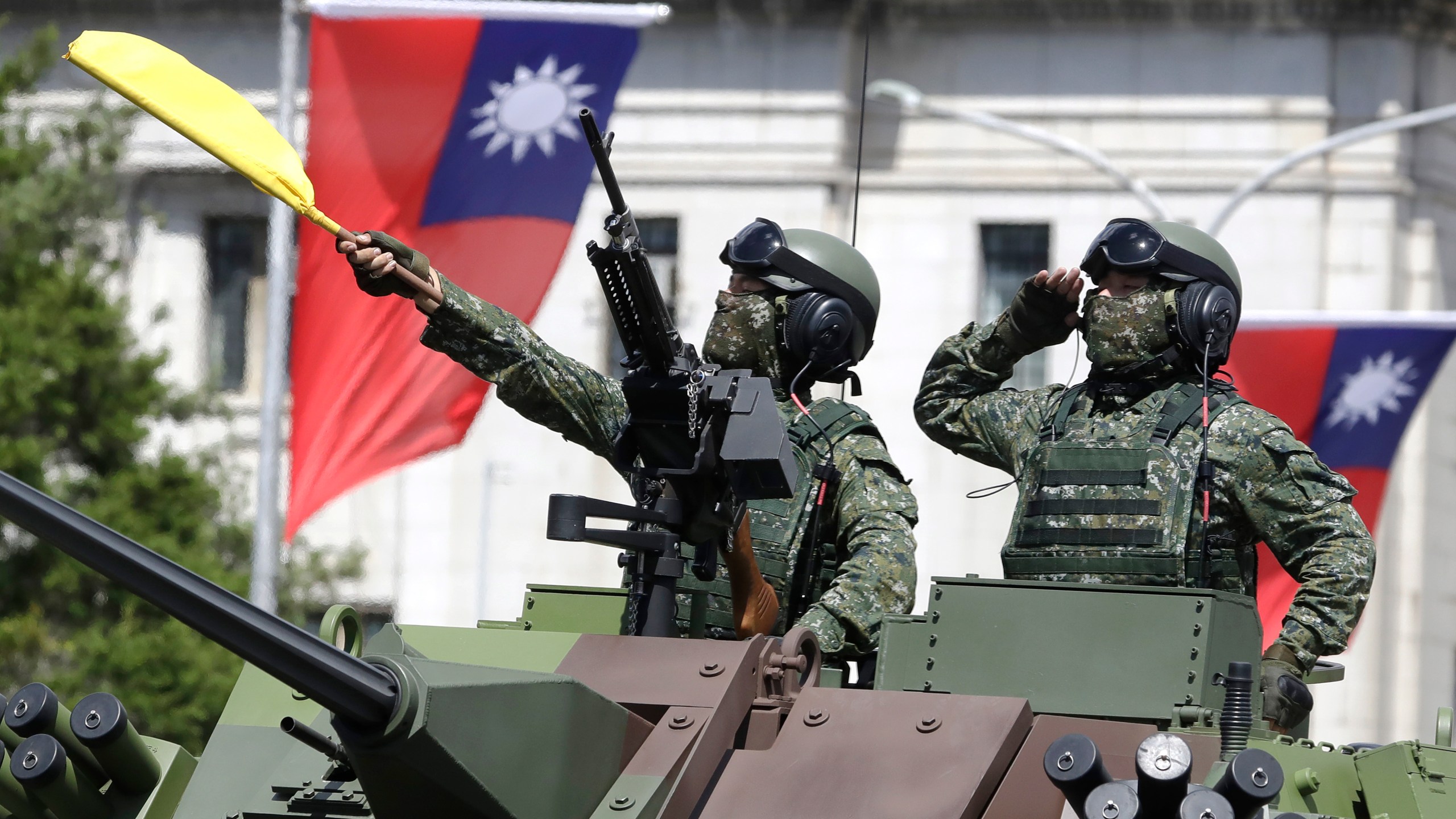 FILE - Taiwanese soldiers salute during National Day celebrations in front of the Presidential Building in Taipei, Taiwan, on Oct. 10, 2021. (AP Photo/Chiang Ying-ying, File)