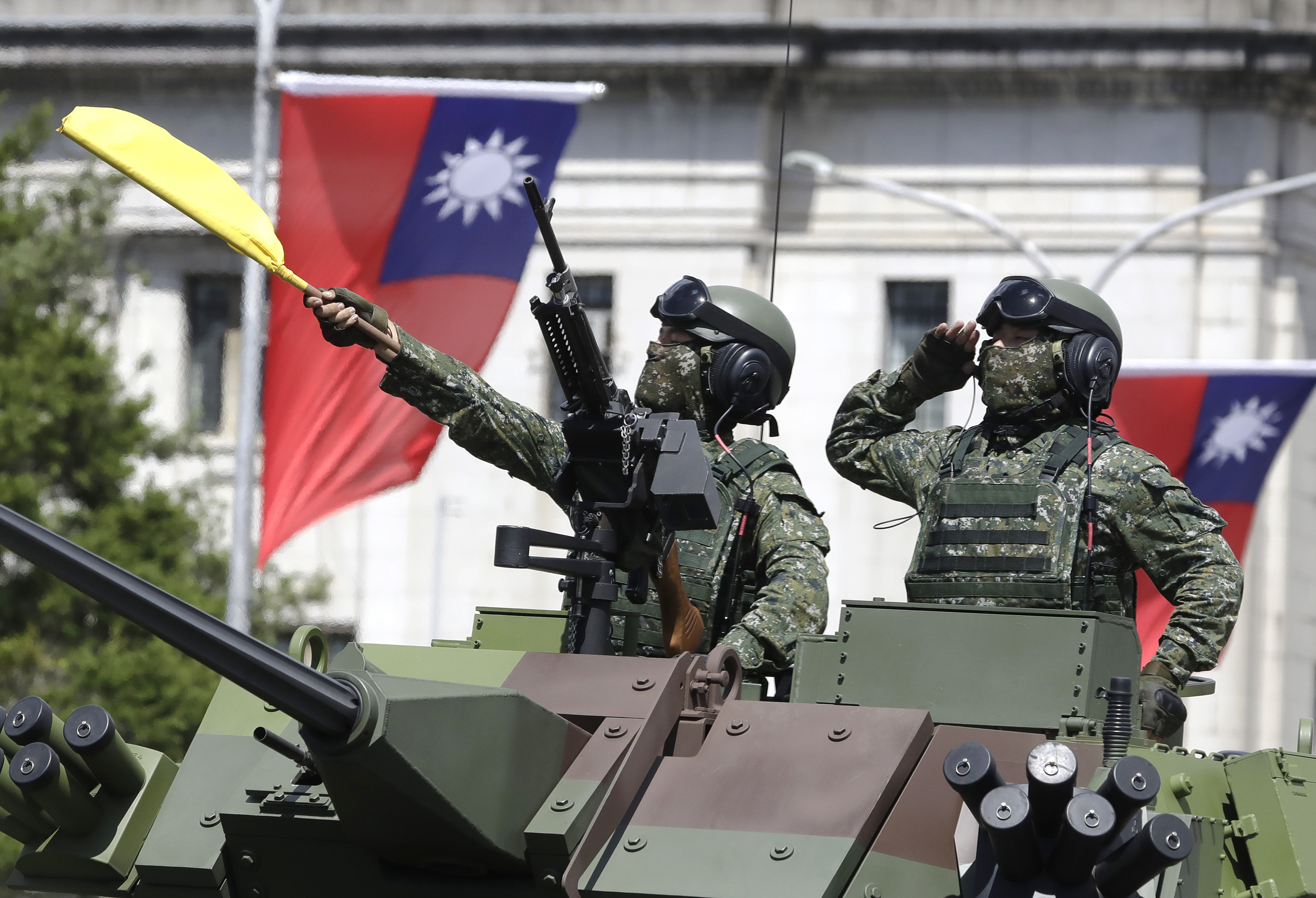 FILE - Taiwanese soldiers salute during National Day celebrations in front of the Presidential Building in Taipei, Taiwan, on Oct. 10, 2021. (AP Photo/Chiang Ying-ying, File)