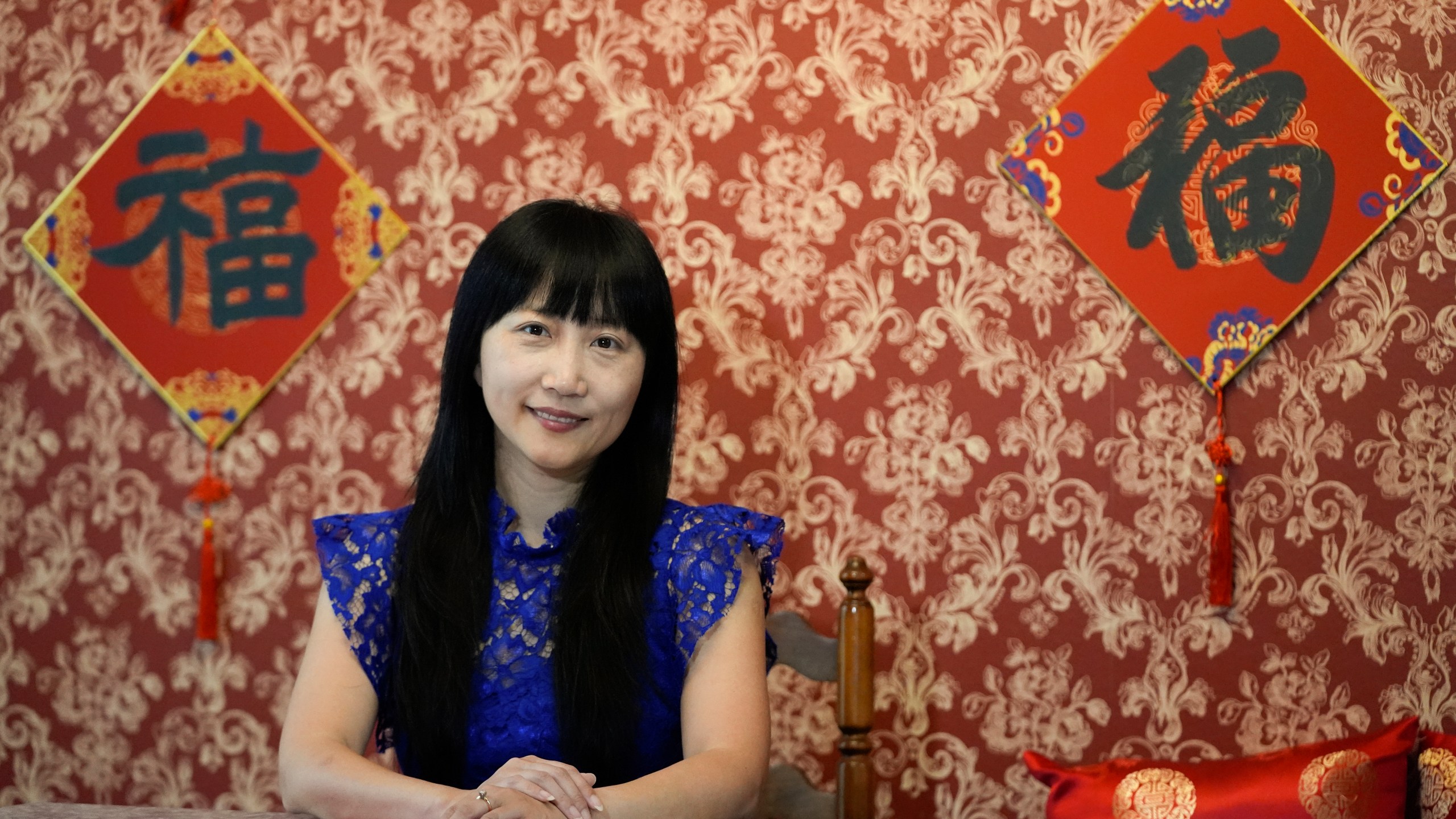 Diana Xue poses for a photo at her home Monday, Oct. 21, 2024, in Orlando, Fla. Xue is a naturalized U.S. citizen born in China who used to vote more Republican but has changed her mind after Florida passed the alien land law. (AP Photo/John Raoux)