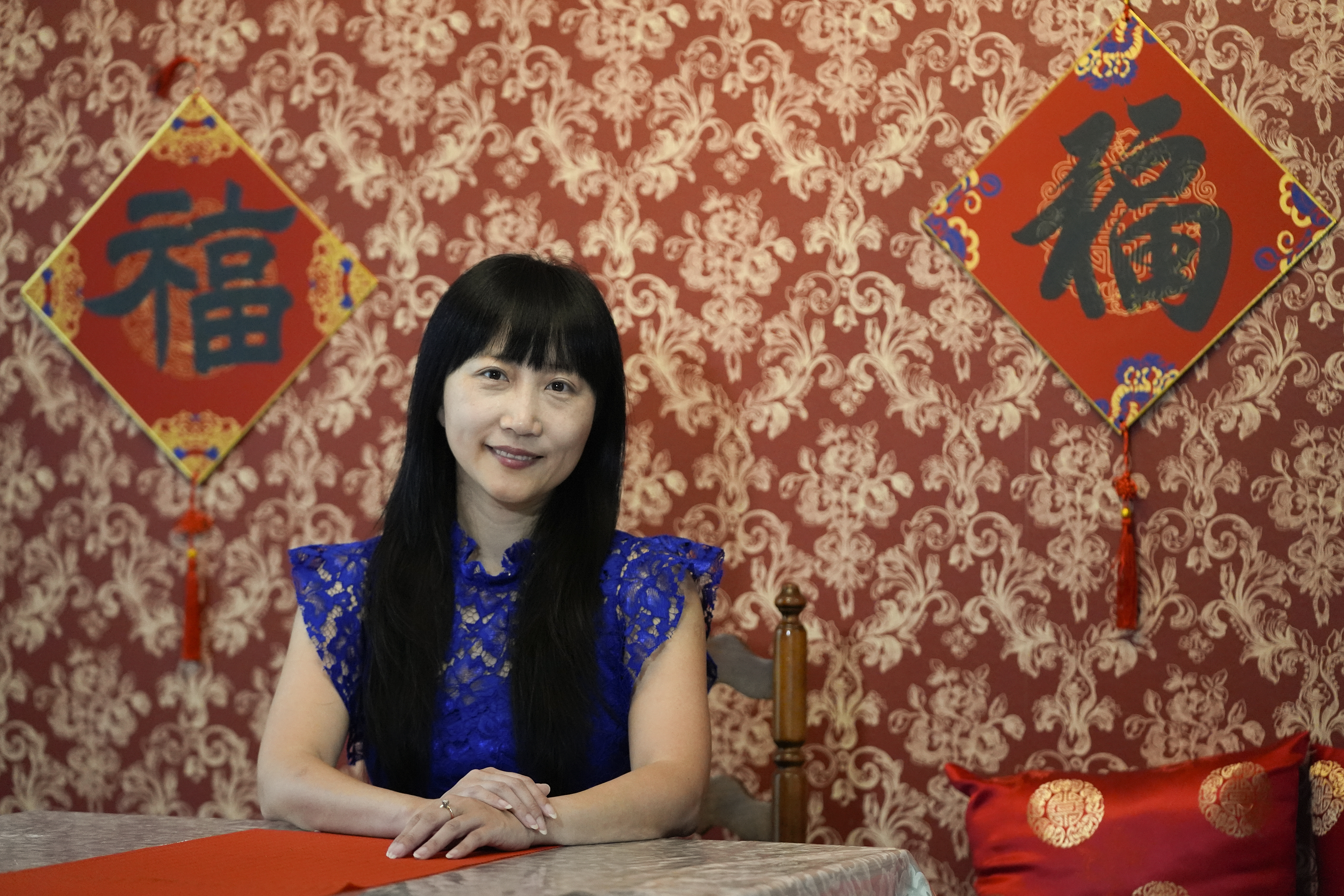 Diana Xue poses for a photo at her home Monday, Oct. 21, 2024, in Orlando, Fla. Xue is a naturalized U.S. citizen born in China who used to vote more Republican but has changed her mind after Florida passed the alien land law. (AP Photo/John Raoux)