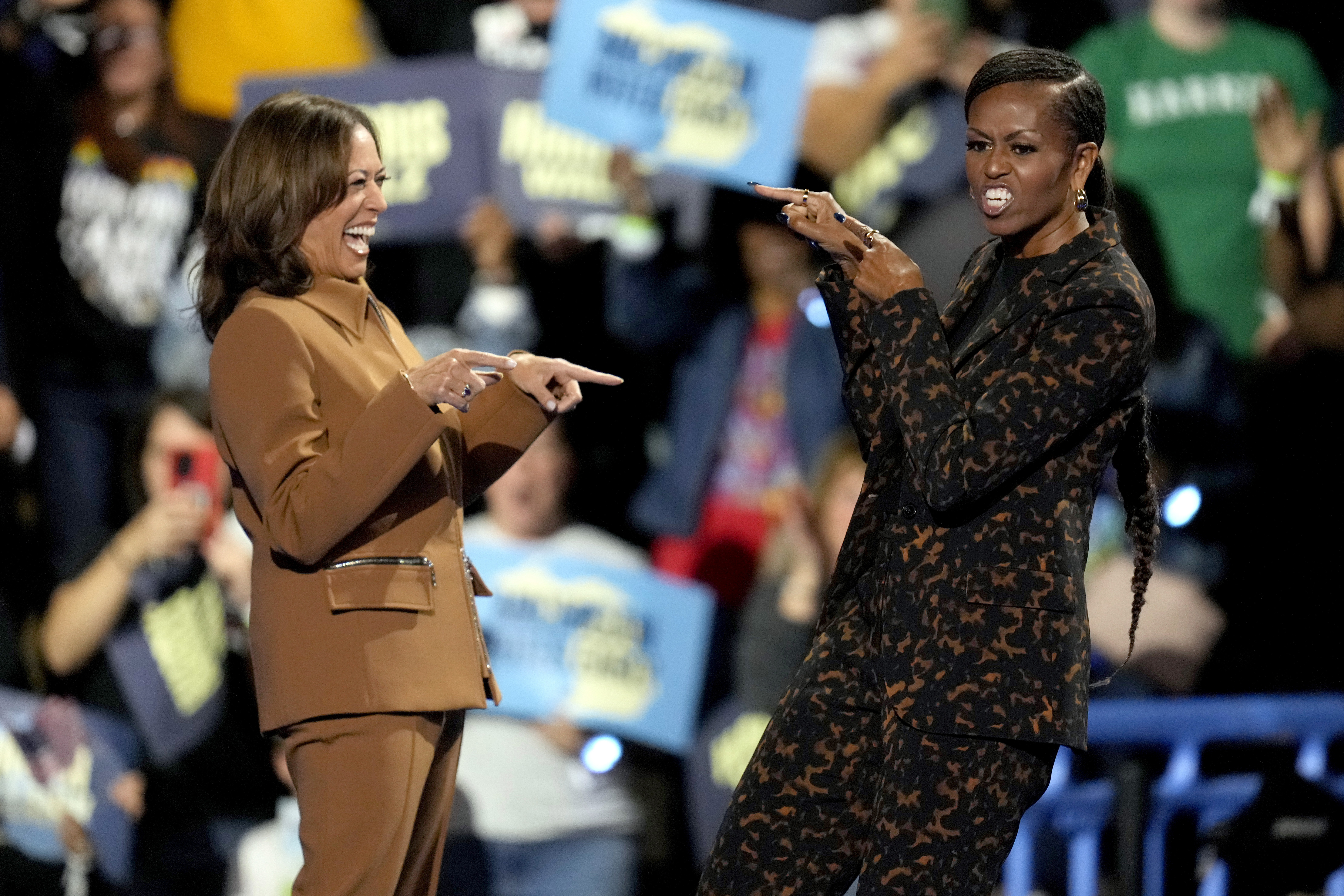 Democratic presidential nominee Vice President Kamala Harris, left, and former first lady Michelle Obama arrive to speak at a campaign rally at the Wings Event Center, Saturday, Oct. 26, 2024, in Kalamazoo, Mich. (AP Photo/Paul Sancya)