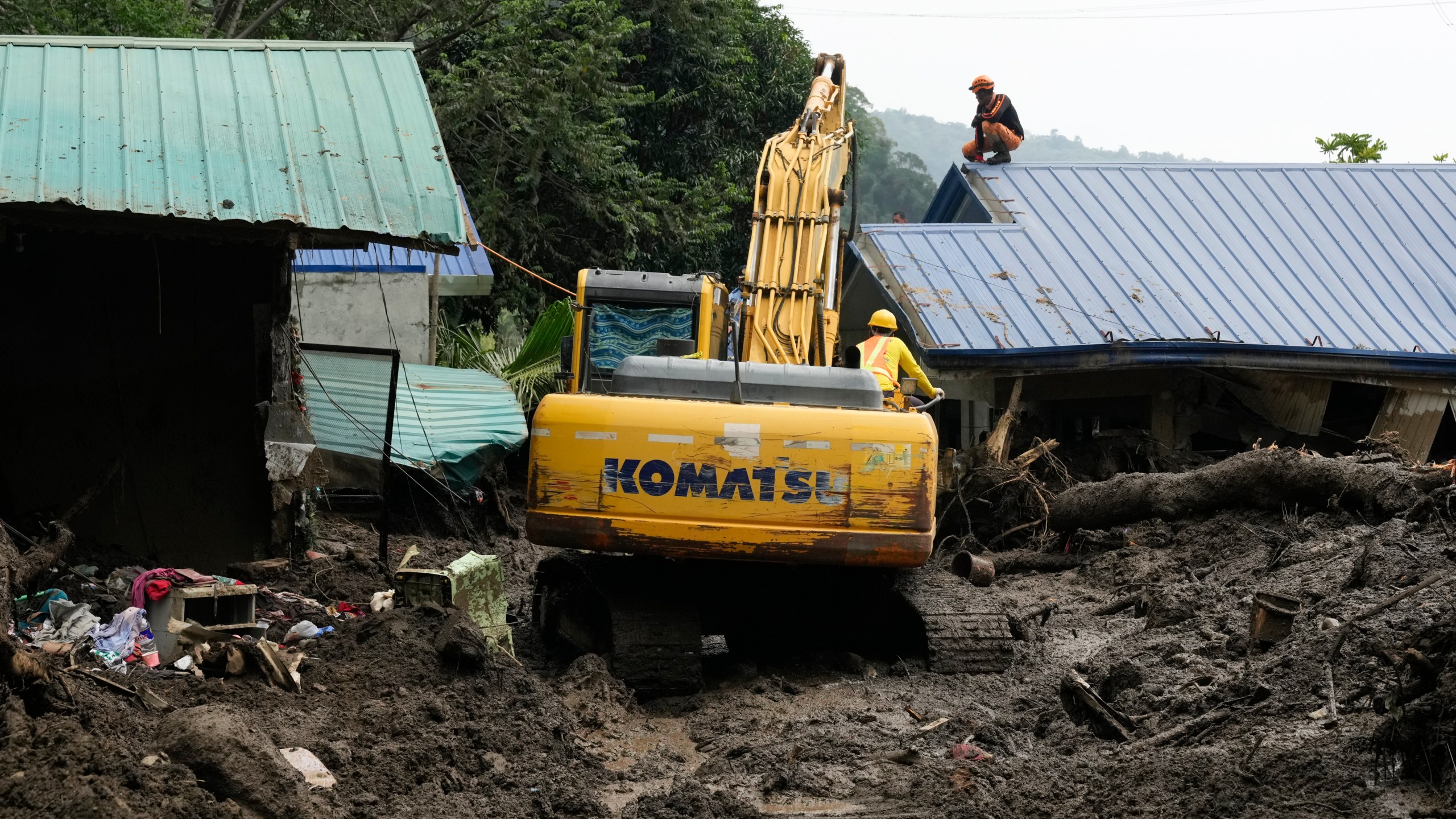 Rescuers work at the site after a recent landslide triggered by Tropical Storm Trami struck Talisay, Batangas province, Philippines leaving thousands homeless and several villagers dead on Saturday, Oct. 26, 2024. (AP Photo/Aaron Favila)