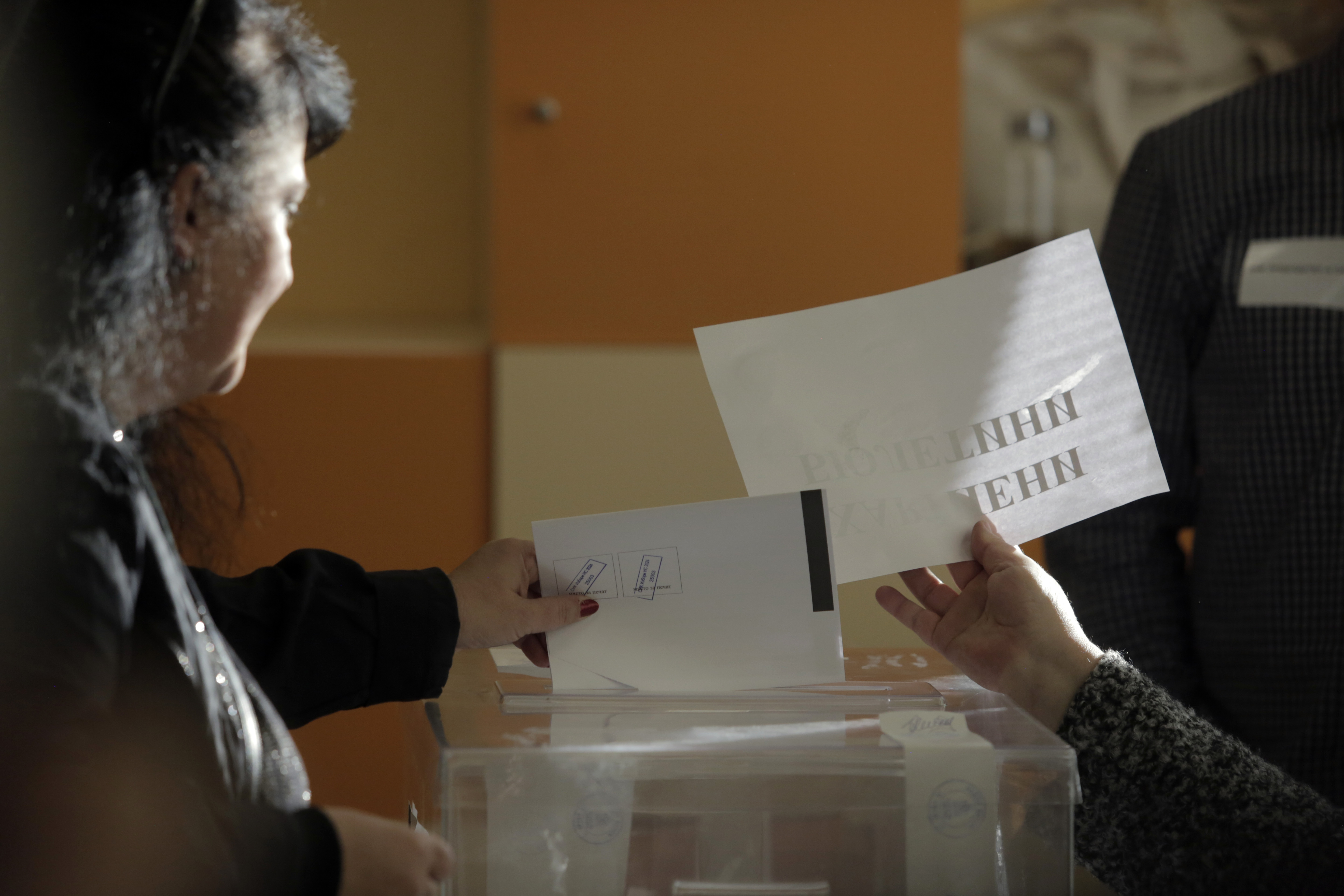 A woman casts a ballot at a polling station during the general elections in Sofia, Sunday, Oct. 27, 2024. (AP Photo/Valentina Petrova)