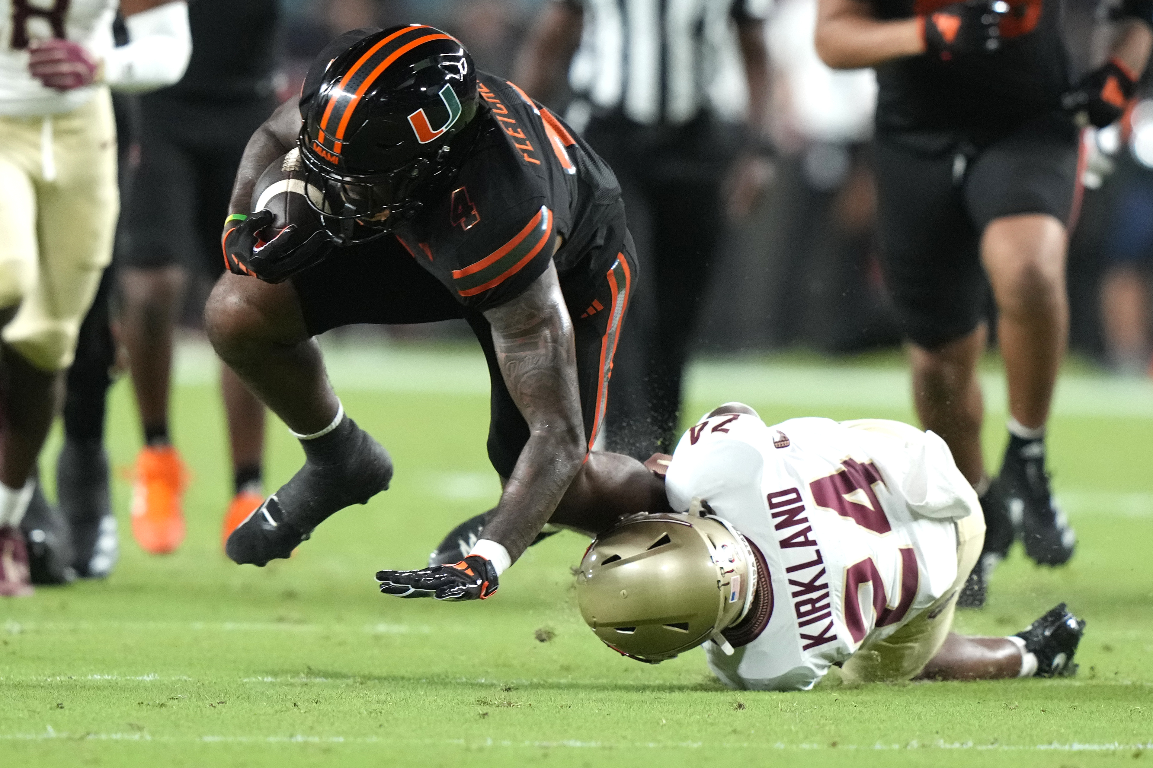 Miami running back Mark Fletcher Jr., left, runs for a first down as Florida State defensive back K.J. Kirkland (24) defends during the first half of an NCAA college football game, Saturday, Oct. 26, 2024, in Miami Gardens, Fla. (AP Photo/Lynne Sladky)