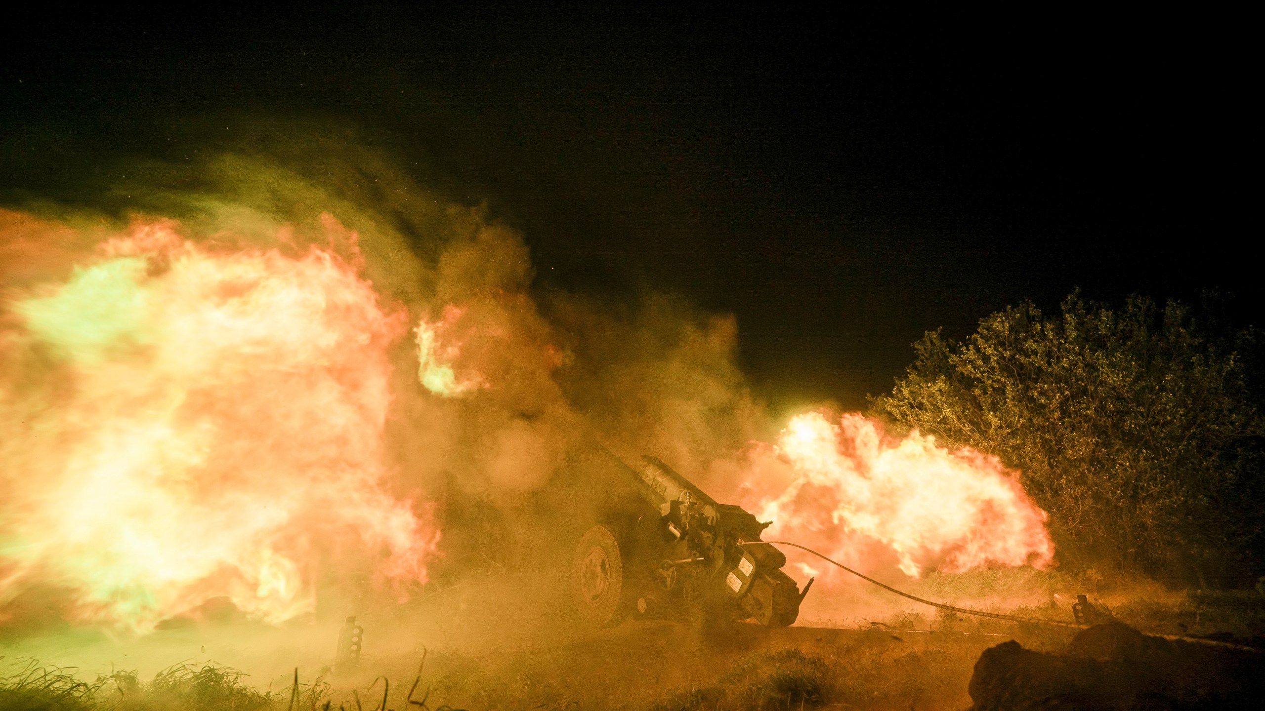 Ukrainian servicemen fire from a 122mm artillery cannon towards Russian positions in Kherson region, Ukraine, Sunday Oct. 27, 2024. (AP Photo/Marko Ivkov)