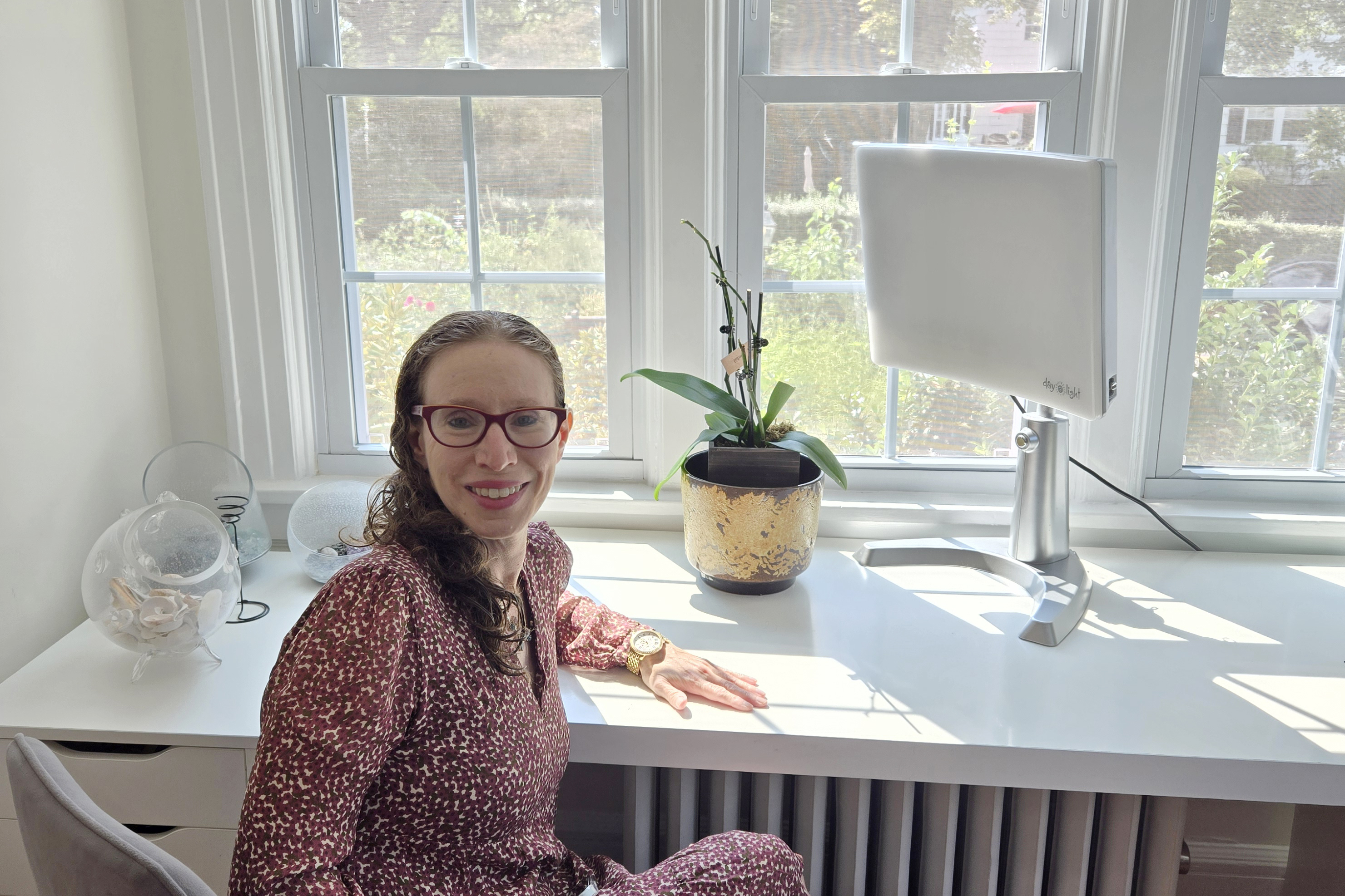 Miriam Cherry poses for a photo in her home where she uses a light therapy device to treat seasonal affective disorder, in Larchmont, New York, on Sept. 4, 2024. (Miriam Cherry via AP)