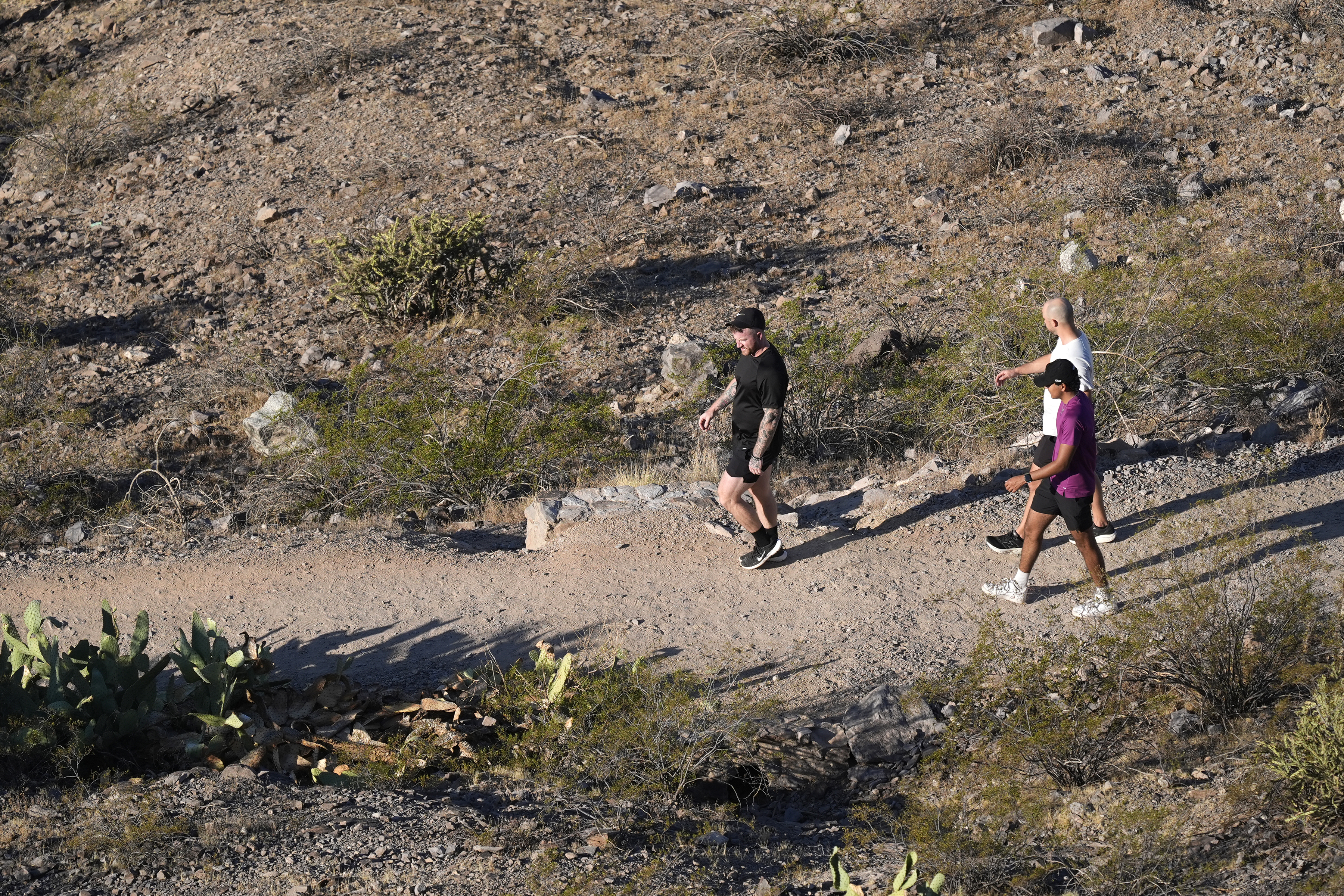 Hikers walk a trail near "A" Mountain Tuesday, Sept. 24, 2024, in Tempe, Ariz. (AP Photo/Ross D. Franklin)