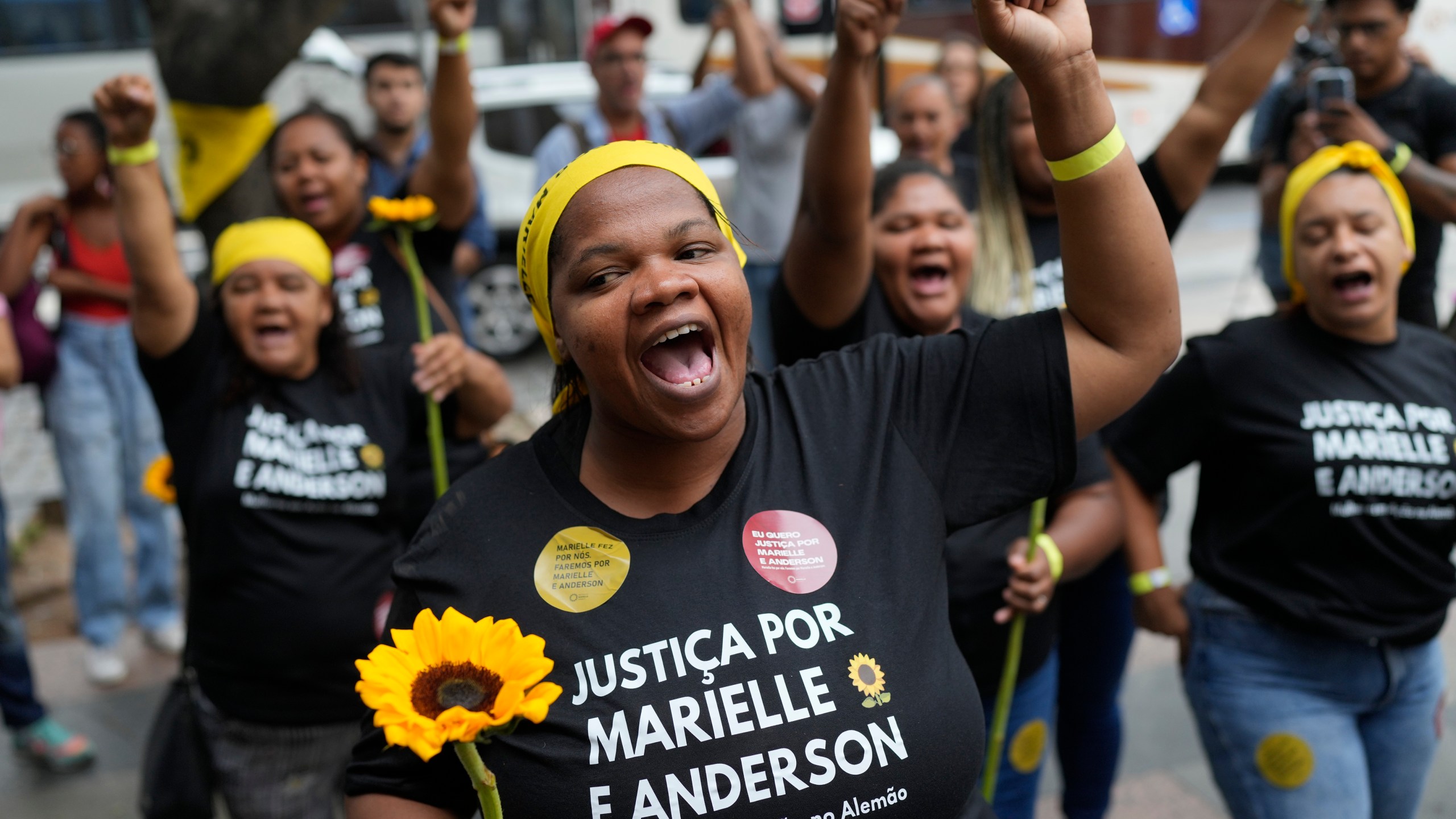 Activists attend a rally prior to the trial of former Rio de Janeiro city councilwoman Marielle Franco's alleged killers outside the Court of Justice, in Rio de Janeiro, Wednesday, Oct. 30, 2024. (AP Photo/Silvia Izquierdo)