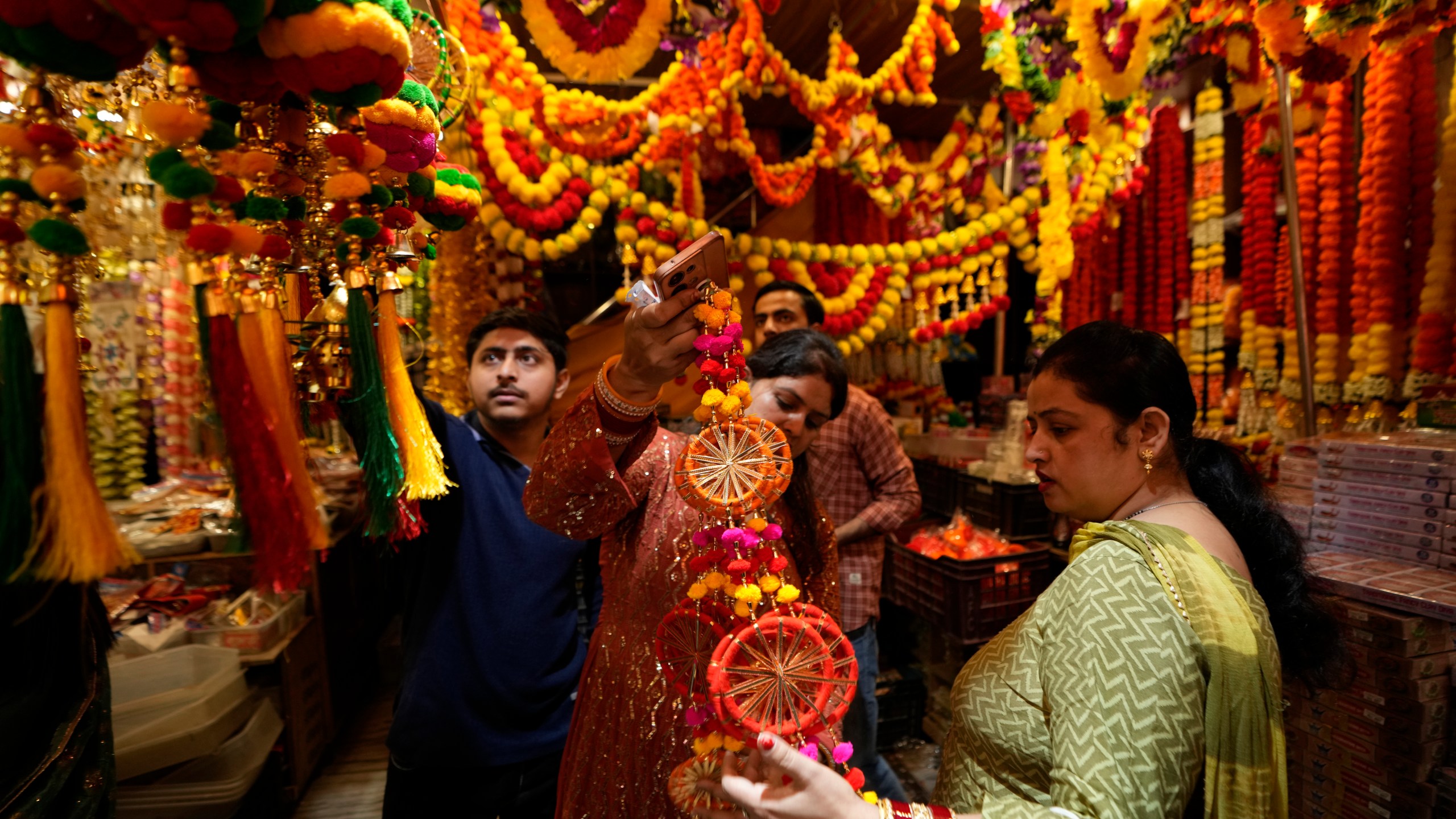 Women shop on the eve of Diwali, the Hindu festival of lights, in Jammu, India, Wednesday, Oct. 30, 2024.Diwali is one of Hinduism's most important festivals, dedicated to the worship of the goddess of wealth Lakshmi. (AP Photo/Channi Anand)