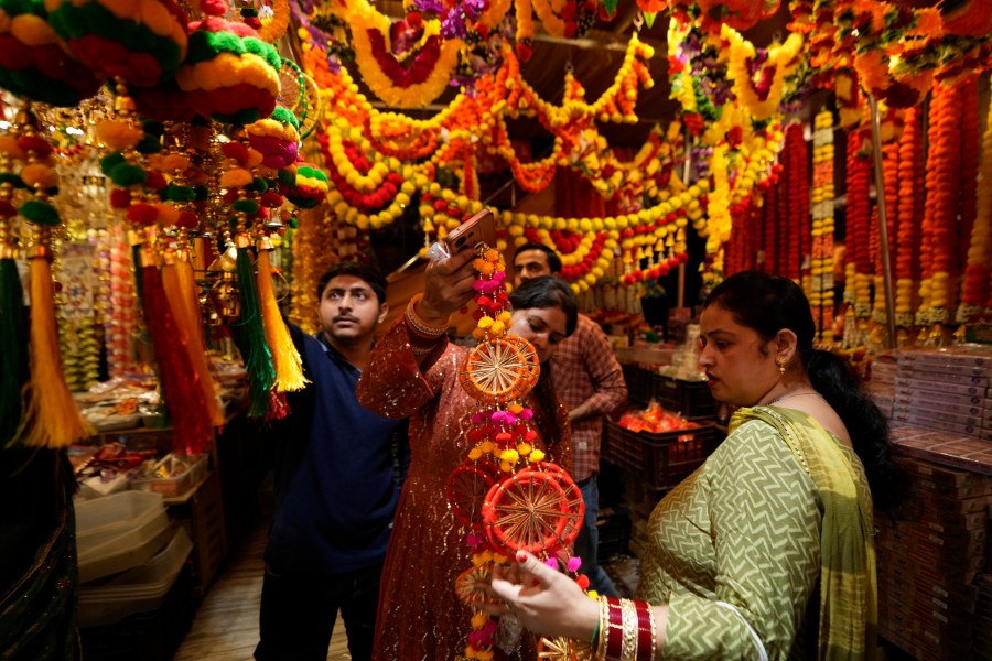 Women shop on the eve of Diwali, the Hindu festival of lights, in Jammu, India, Wednesday, Oct. 30, 2024.Diwali is one of Hinduism's most important festivals, dedicated to the worship of the goddess of wealth Lakshmi. (AP Photo/Channi Anand)