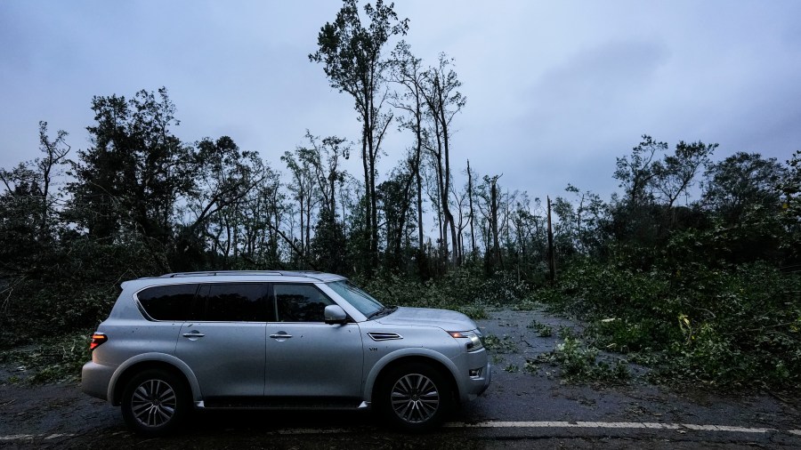 FILE - Vehicles move slowly around trees that have fallen after Hurricane Helene moved through the area, Sept. 27, 2024, in Valdosta, Ga. (AP Photo/Mike Stewart, File)