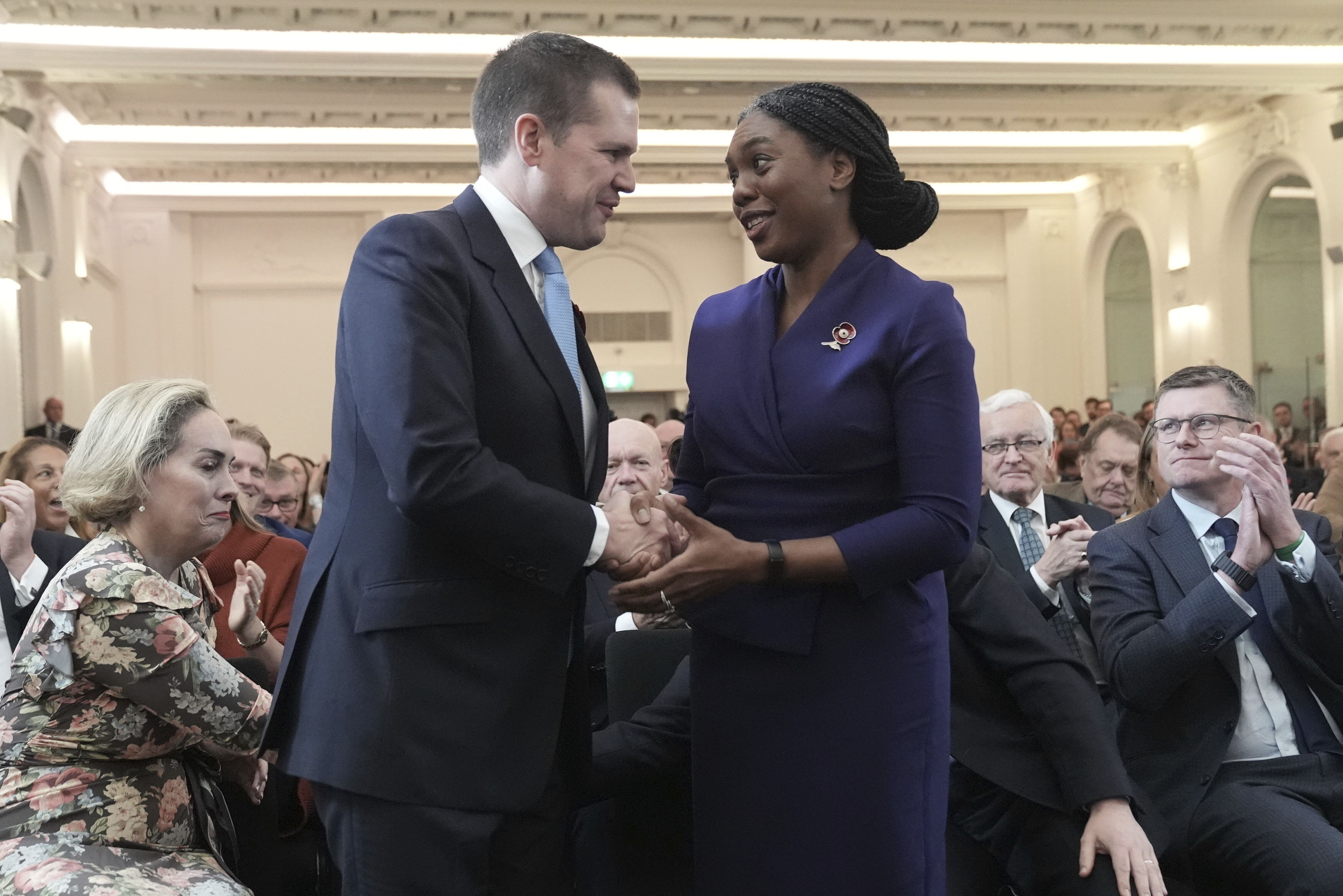 Britain's Member of Parliament Kemi Badenoch is congratulated by Robert Jenrick after being announced as the new Conservative Party leader following the vote by party members, at 8 Northumberland Avenue in central London, Saturday Nov. 2, 2024. (Stefan Rousseau/PA via AP)