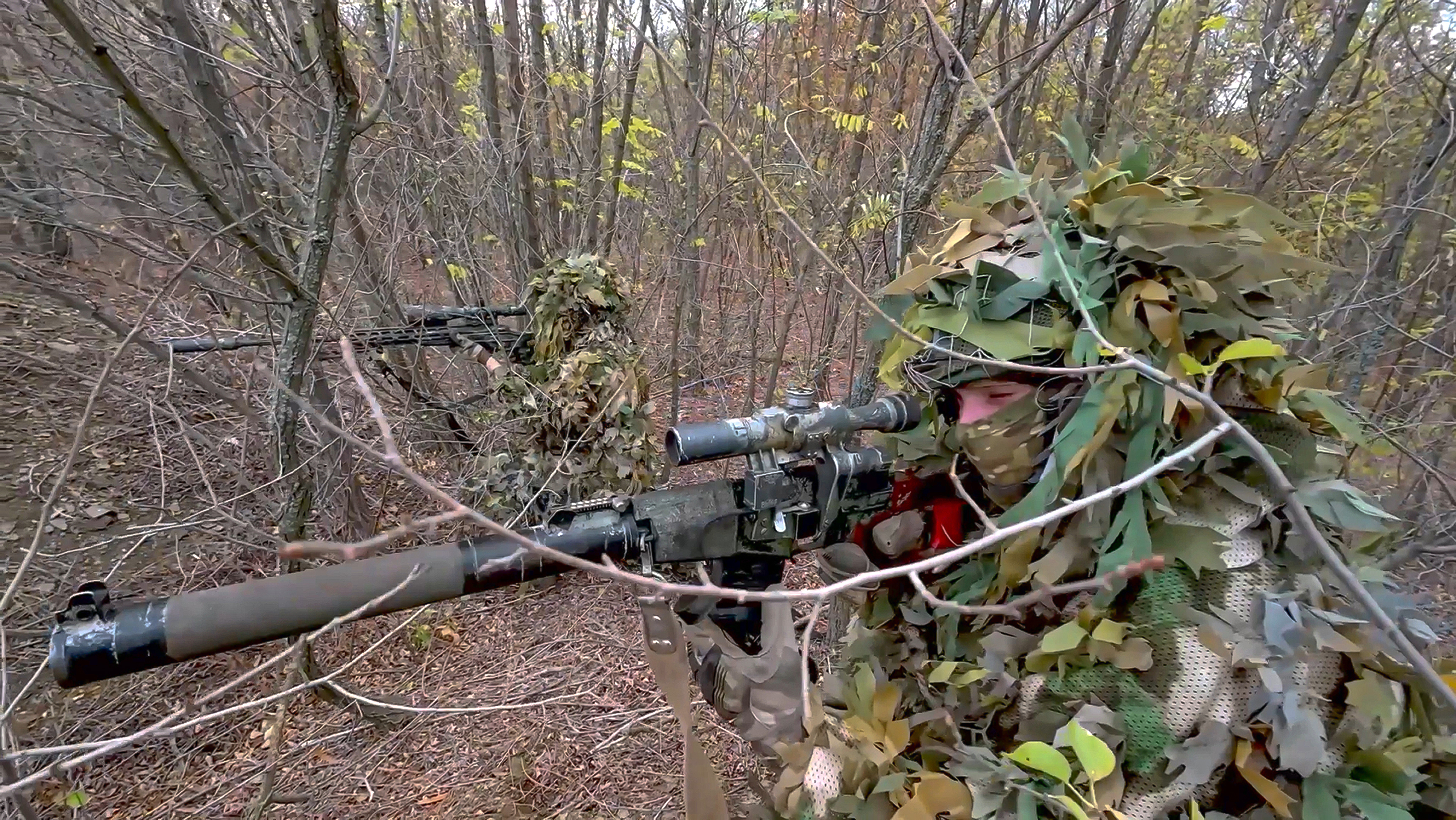 In this image made from video released by the Russian Defense Ministry on Thursday, Oct. 31, 2024, Russian snipers fire towards Ukrainian forces from an undisclosed location. (Russian Defense Ministry Press Service via AP)