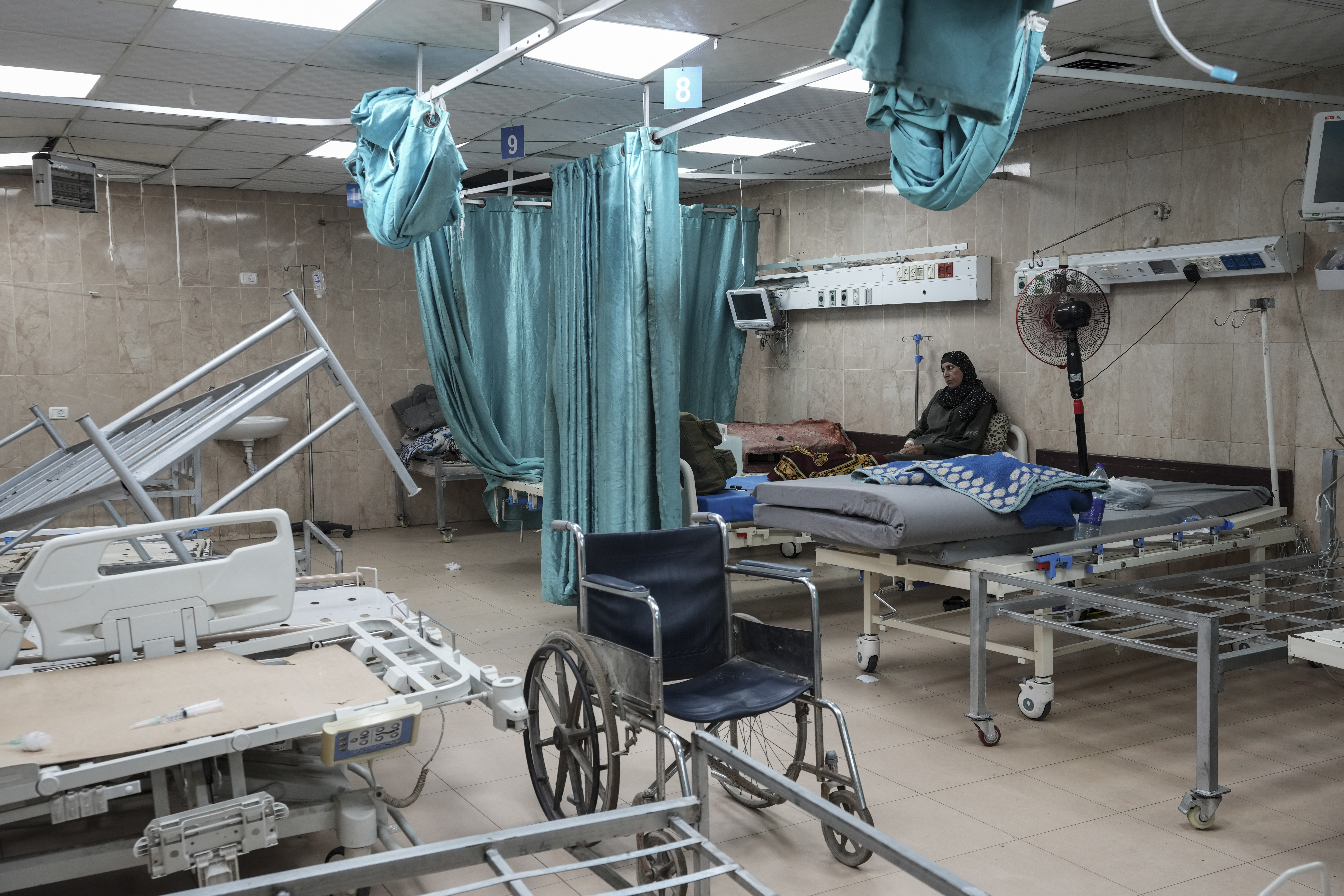 FILE - A woman sits on a bed in a room of the Al-Aqsa Martyrs hospital in Deir al Balah, Gaza Strip, Aug. 25, 2024. (AP Photo/Abdel Kareem Hana, File)