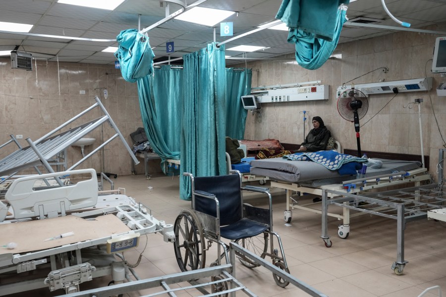 FILE - A woman sits on a bed in a room of the Al-Aqsa Martyrs hospital in Deir al Balah, Gaza Strip, Aug. 25, 2024. (AP Photo/Abdel Kareem Hana, File)