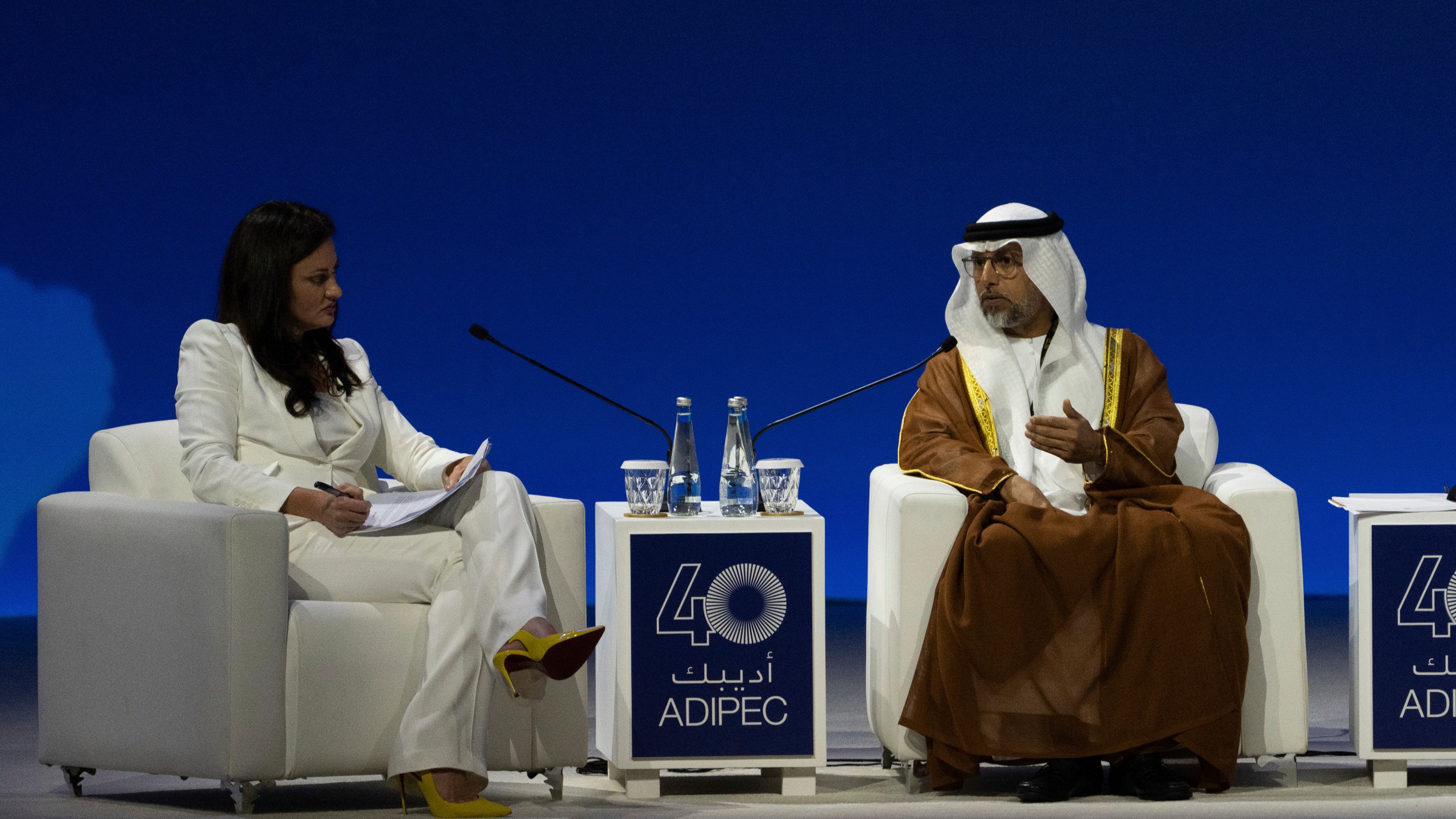 Moderator Hadley Gamble, left, looks on as UAE Minister of Energy and Infrastructure Suhail al-Mazrouei talks in a panel during the the inaugural session of annual Abu Dhabi International Petroleum Exhibition and Conference (ADIPEC) in Abu Dhabi, United Arab Emirates, Monday, Nov. 4, 2024. (AP Photo/Altaf Qadri)