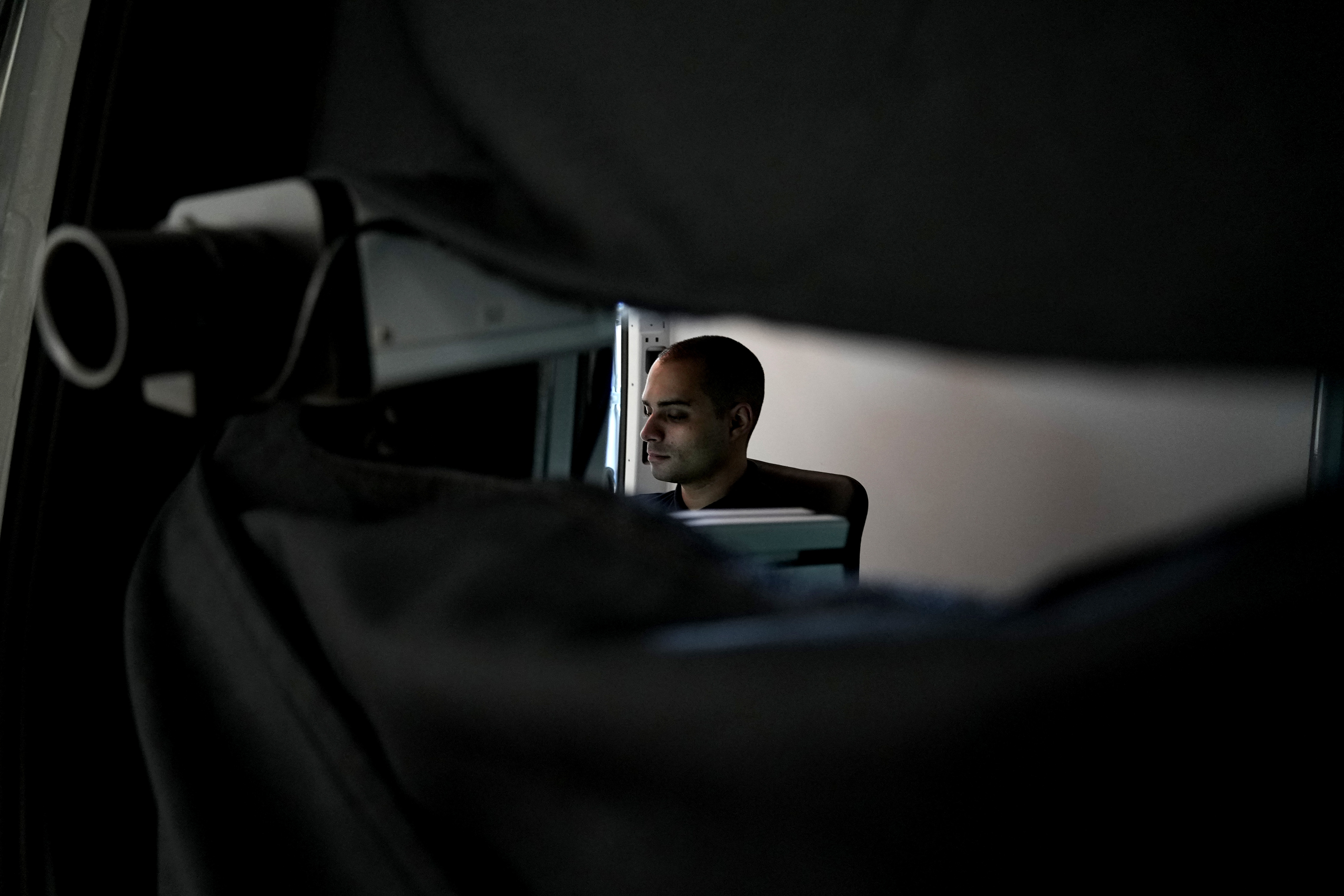 Charalambos Madritis sits in front of a computer laptop inside a specially configured van equipped with highly sensitive sensors able to detect radioactive materials, parked inside the U.S.-funded Cyprus Center for Land, Open Seas and Port Security (CYCLOPS) in Larnaca, Cyprus, on Monday, Nov. 4, 2024. (AP Photo/Petros Karadjias)