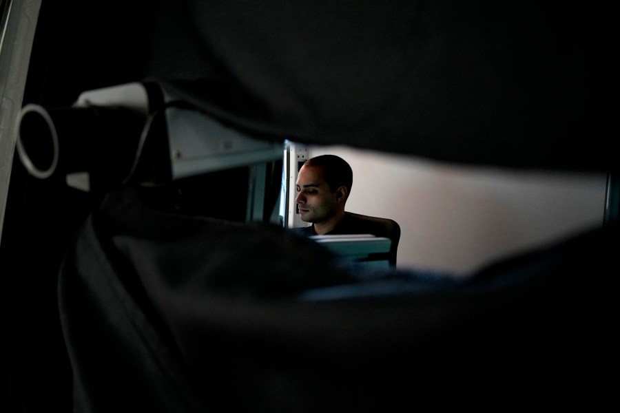 Charalambos Madritis sits in front of a computer laptop inside a specially configured van equipped with highly sensitive sensors able to detect radioactive materials, parked inside the U.S.-funded Cyprus Center for Land, Open Seas and Port Security (CYCLOPS) in Larnaca, Cyprus, on Monday, Nov. 4, 2024. (AP Photo/Petros Karadjias)