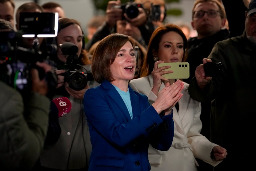 Moldova's President Maia Sandu claps her hands next to media as preliminary results are announced for the presidential election runoff in Chisinau, Moldova, Sunday, Nov. 3, 2024. (AP Photo/Vadim Ghirda)