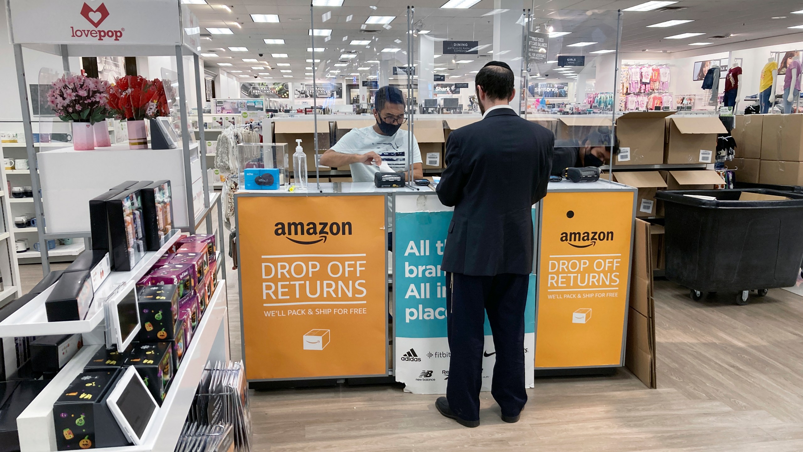 FILE - People return items purchased online at an Amazon counter inside a Kohl's department store in Clifton, New Jersey, on September 3, 2021. (AP Photo/Ted Shaffrey, File)