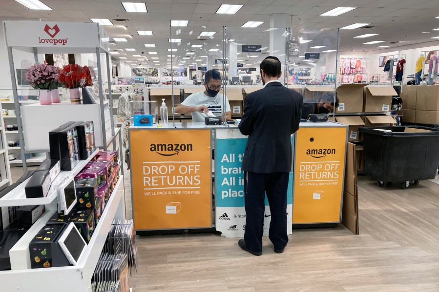 FILE - People return items purchased online at an Amazon counter inside a Kohl's department store in Clifton, New Jersey, on September 3, 2021. (AP Photo/Ted Shaffrey, File)