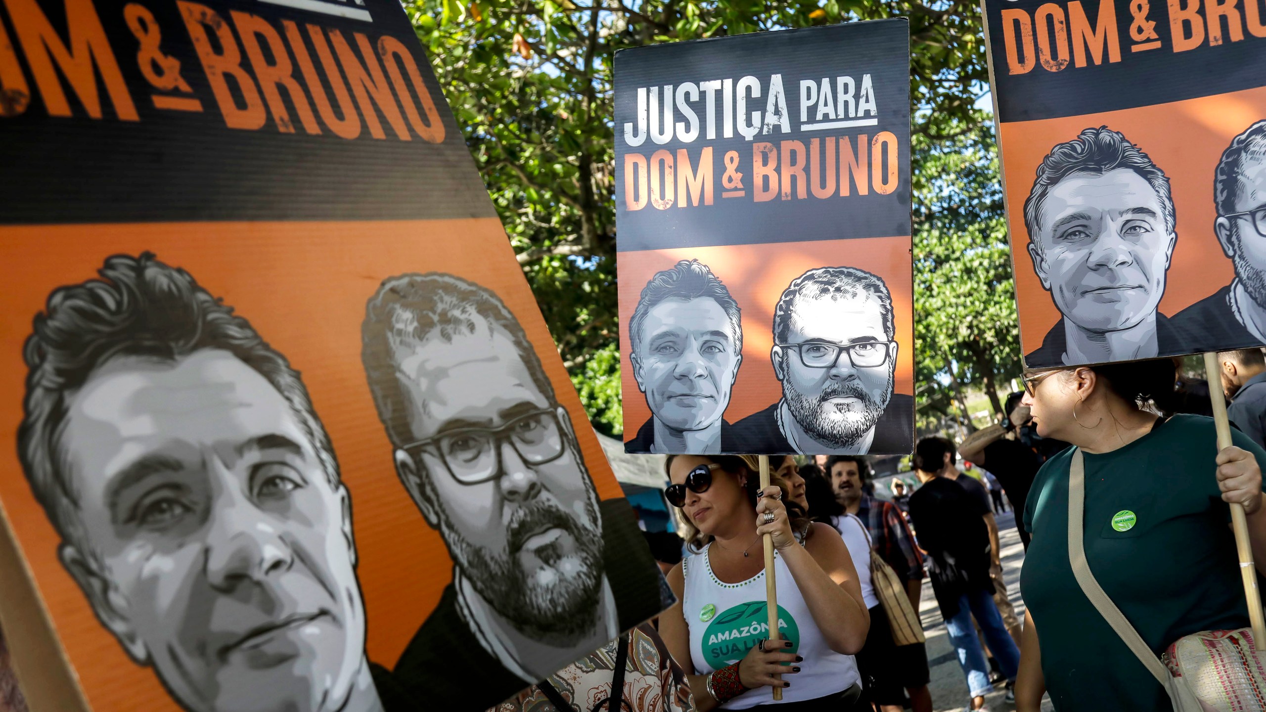 FILE - The relatives of late British journalist Dom Phillips and activists hold banners with his image, left side, and that of Indigenous activist Bruno Pereira, with the Portuguese message: “Justice for Dom and Bruno” during the one-year anniversary since their murders, in Rio de Janeiro, Brazil, June 5, 2023. (AP Photo/Bruna Prado, File)