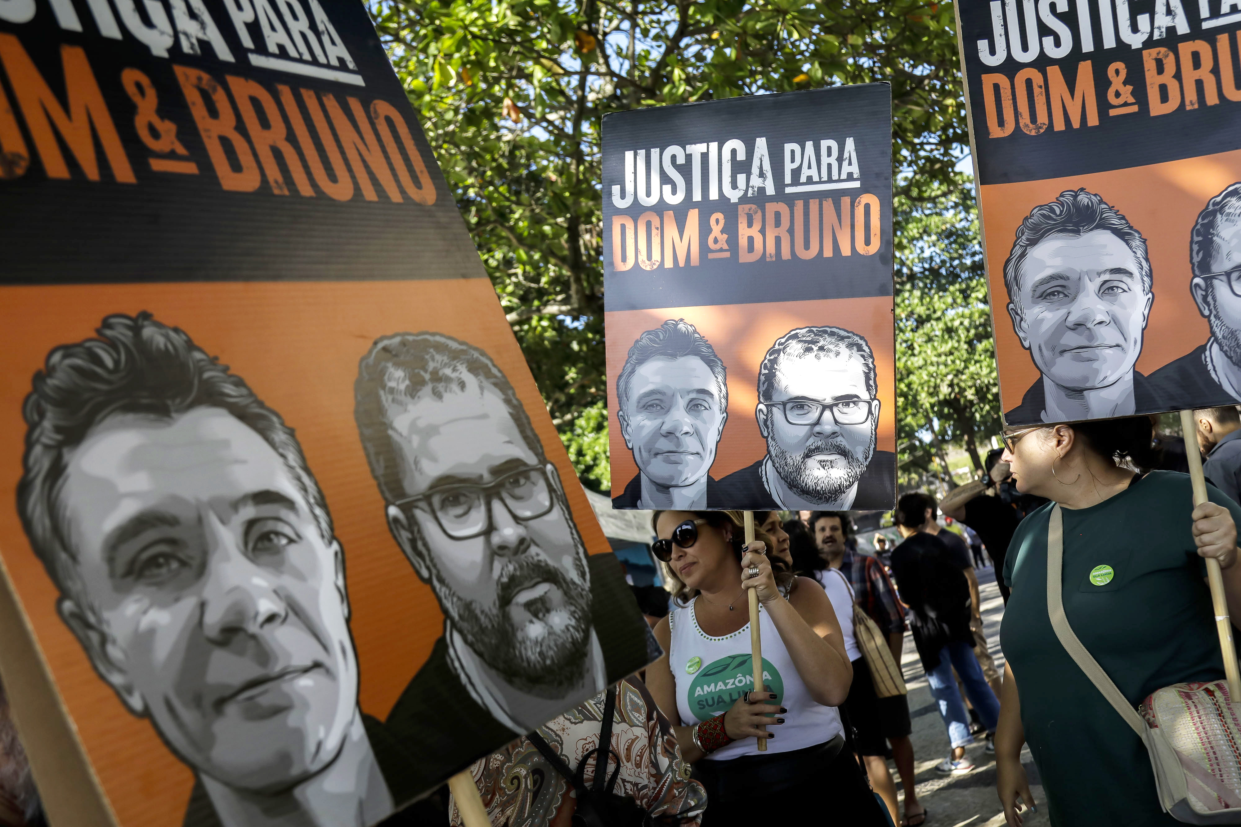 FILE - The relatives of late British journalist Dom Phillips and activists hold banners with his image, left side, and that of Indigenous activist Bruno Pereira, with the Portuguese message: “Justice for Dom and Bruno” during the one-year anniversary since their murders, in Rio de Janeiro, Brazil, June 5, 2023. (AP Photo/Bruna Prado, File)