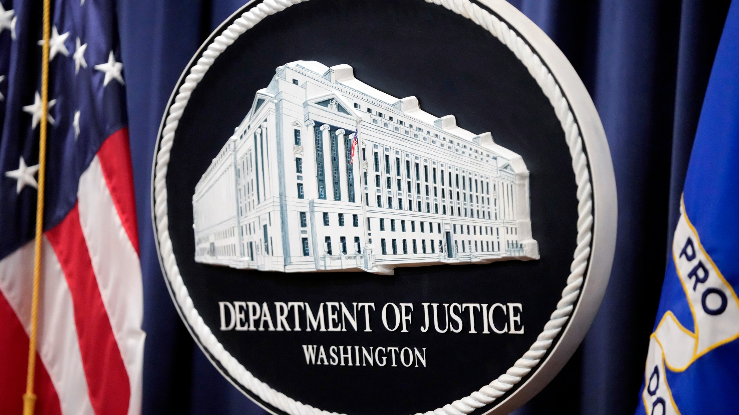 FILE - The logo for the Justice Department is seen before a news conference at the Department of Justice, Aug. 23, 2024, in Washington. (AP Photo/Mark Schiefelbein, File)