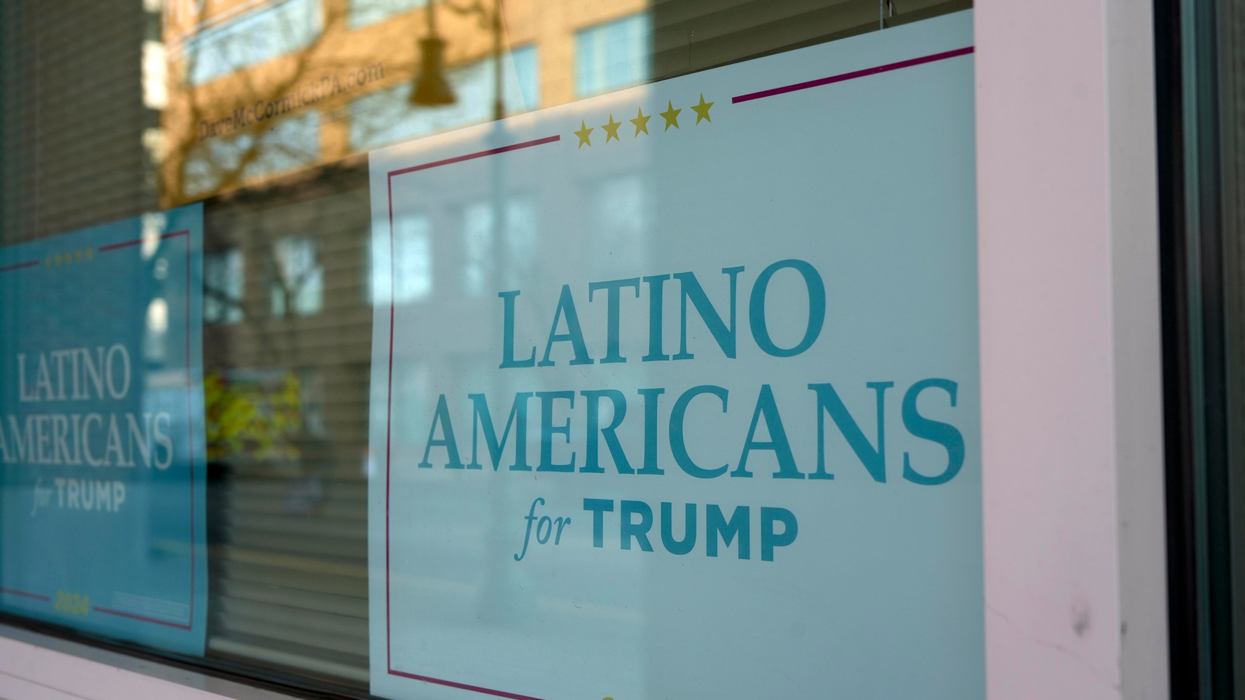 A sign is displayed at an office near the arena where Donald Trump held a rally in Reading, Pa., Monday, Nov. 4, 2024. (AP Photo/Luis Andres Henao)