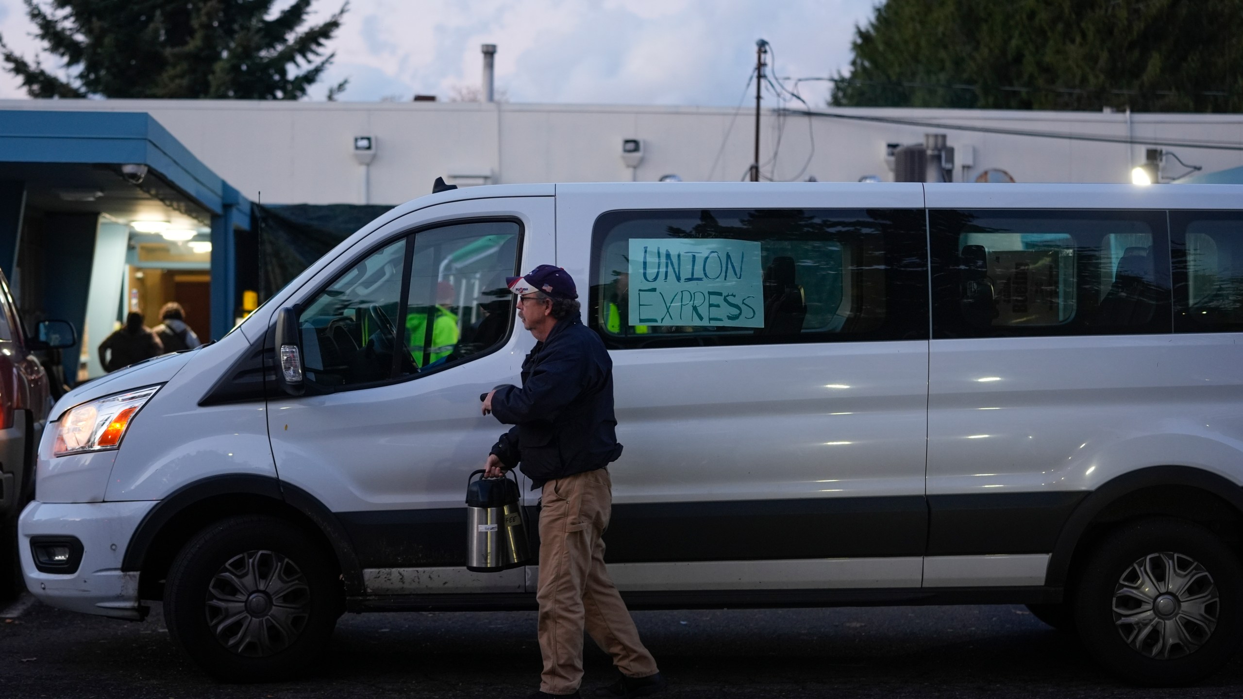 A Boeing employee driving a "union express" van carries carafes as workers vote on a new contract offer from the company Monday, Nov. 4, 2024, at the Aerospace Machinists Union hall in Renton, Wash. (AP Photo/Lindsey Wasson)