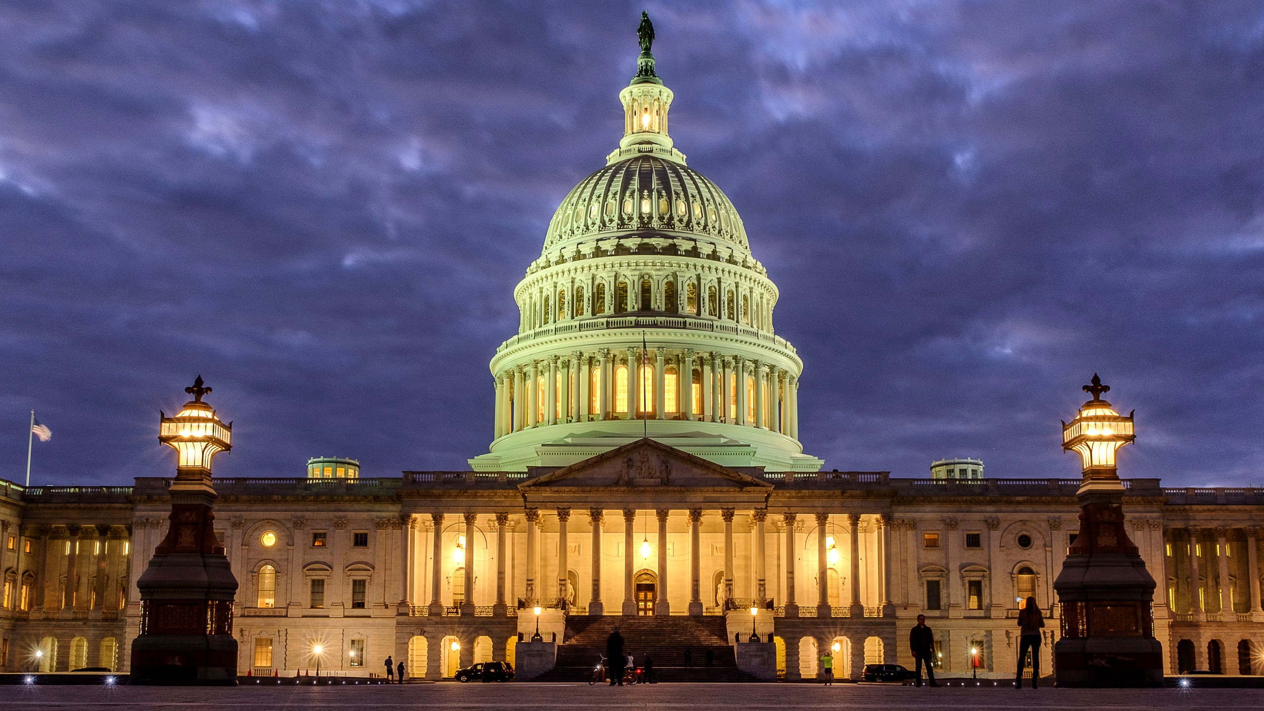 FILE - Lights shine inside the U.S. Capitol Building as night falls on Jan. 21, 2018, in Washington. (AP Photo/J. David Ake, File)