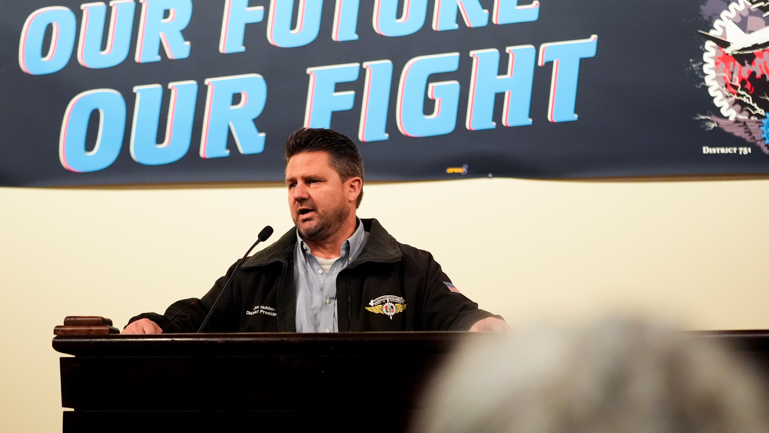 IAM District 751 president Jon Holden speaks to union members while announcing that they voted to accept a new contract offer from Boeing, Monday, Nov. 4, 2024, at their union Hall in Seattle. (AP Photo/Lindsey Wasson)