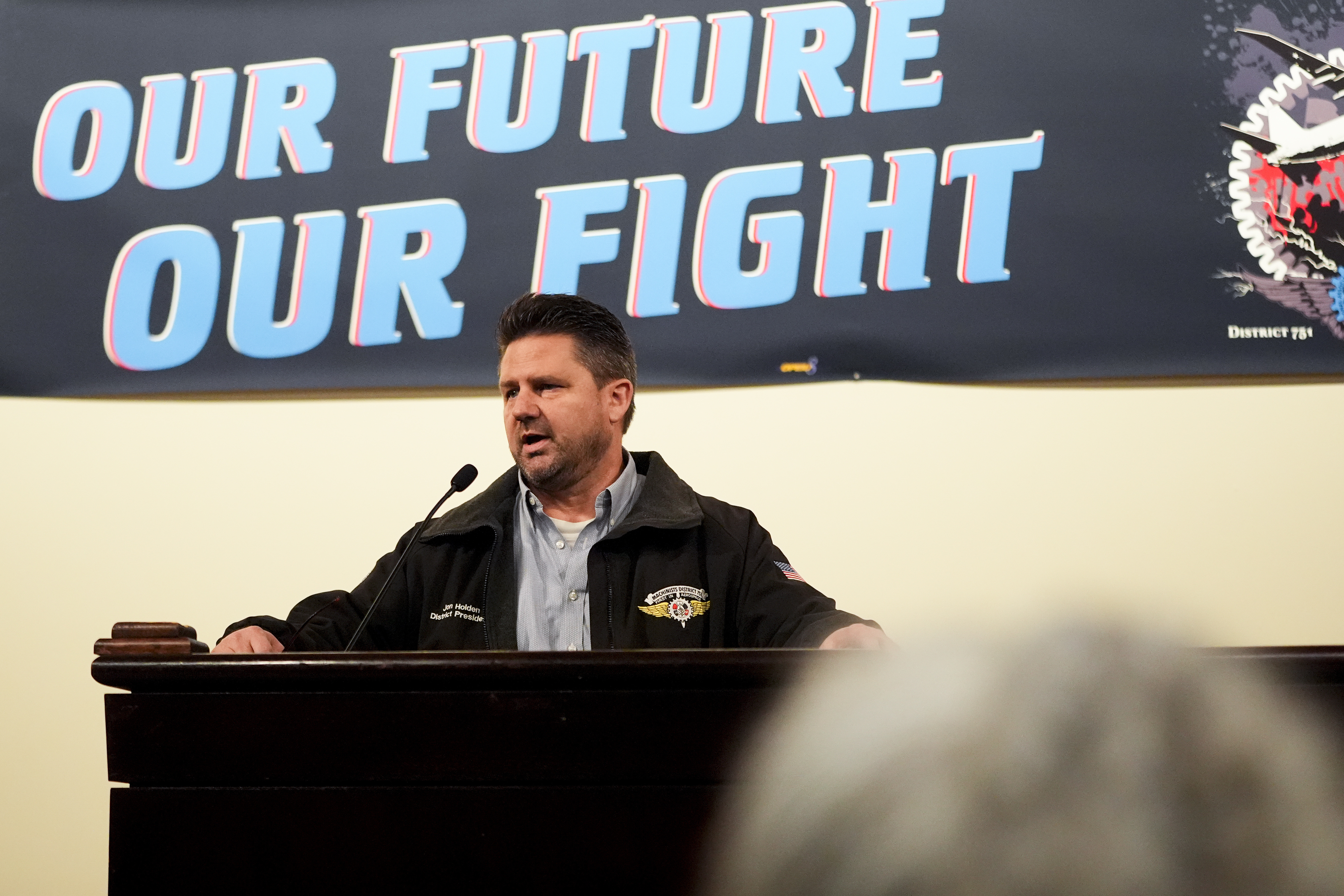 IAM District 751 president Jon Holden speaks to union members while announcing that they voted to accept a new contract offer from Boeing, Monday, Nov. 4, 2024, at their union Hall in Seattle. (AP Photo/Lindsey Wasson)