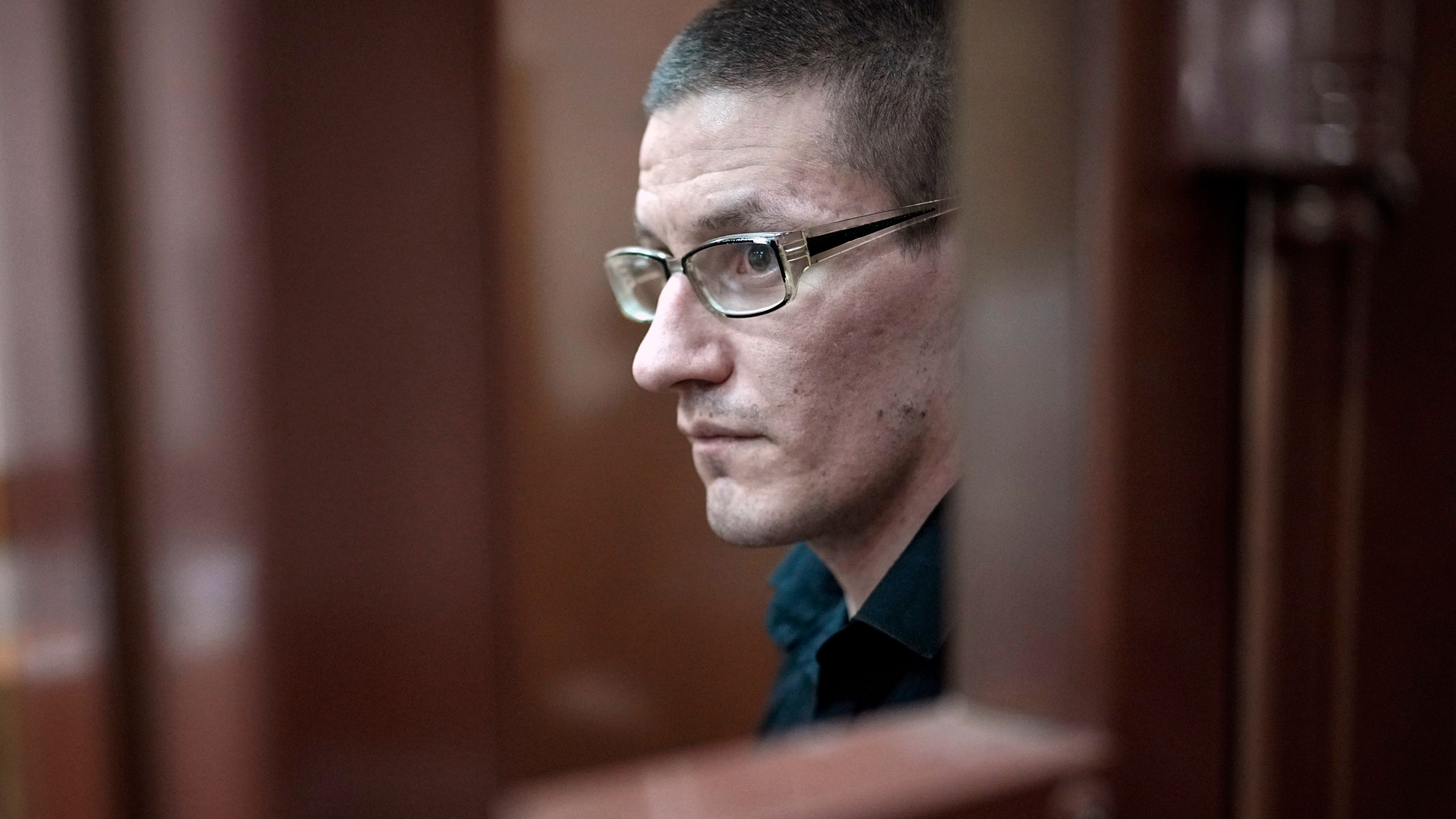 FILE -Robert Woodland, a Russia-born U.S. citizen, stands in a glass cage during a court hearing, July 4, 2024, in Moscow, Russia. (AP Photo/Alexander Zemlianichenko, File)