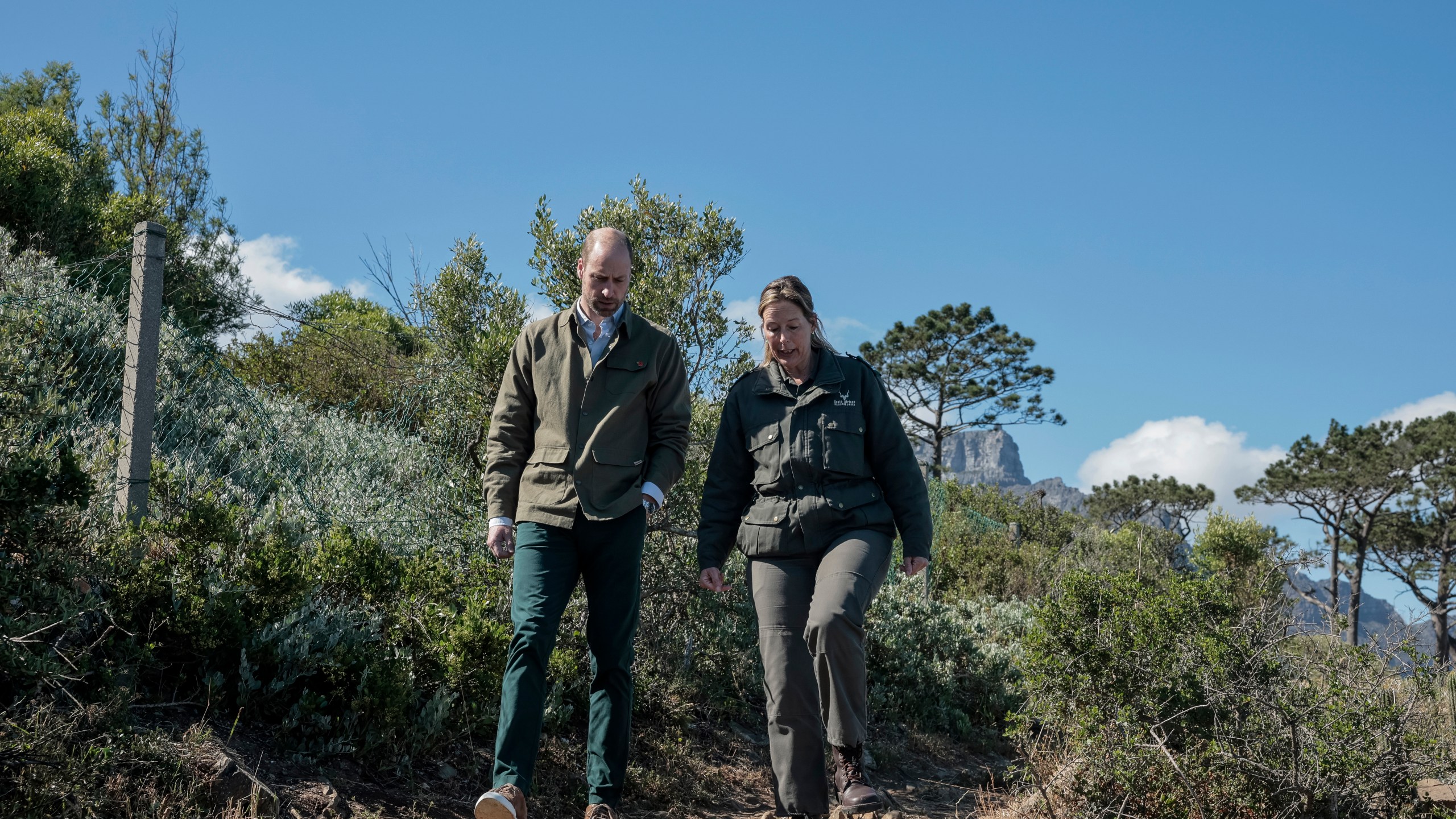 Britain's Prince William, left, talks with Park Manager for Table Mountain National Park Megan Taplin, right, while visiting Signal Hill in Cape Town, South Africa, Tuesday, Nov. 5, 2024. (Gianluigi Guercia/Pool via AP)