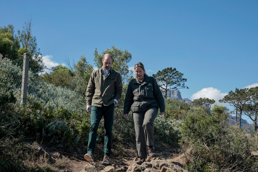 Britain's Prince William, left, talks with Park Manager for Table Mountain National Park Megan Taplin, right, while visiting Signal Hill in Cape Town, South Africa, Tuesday, Nov. 5, 2024. (Gianluigi Guercia/Pool via AP)