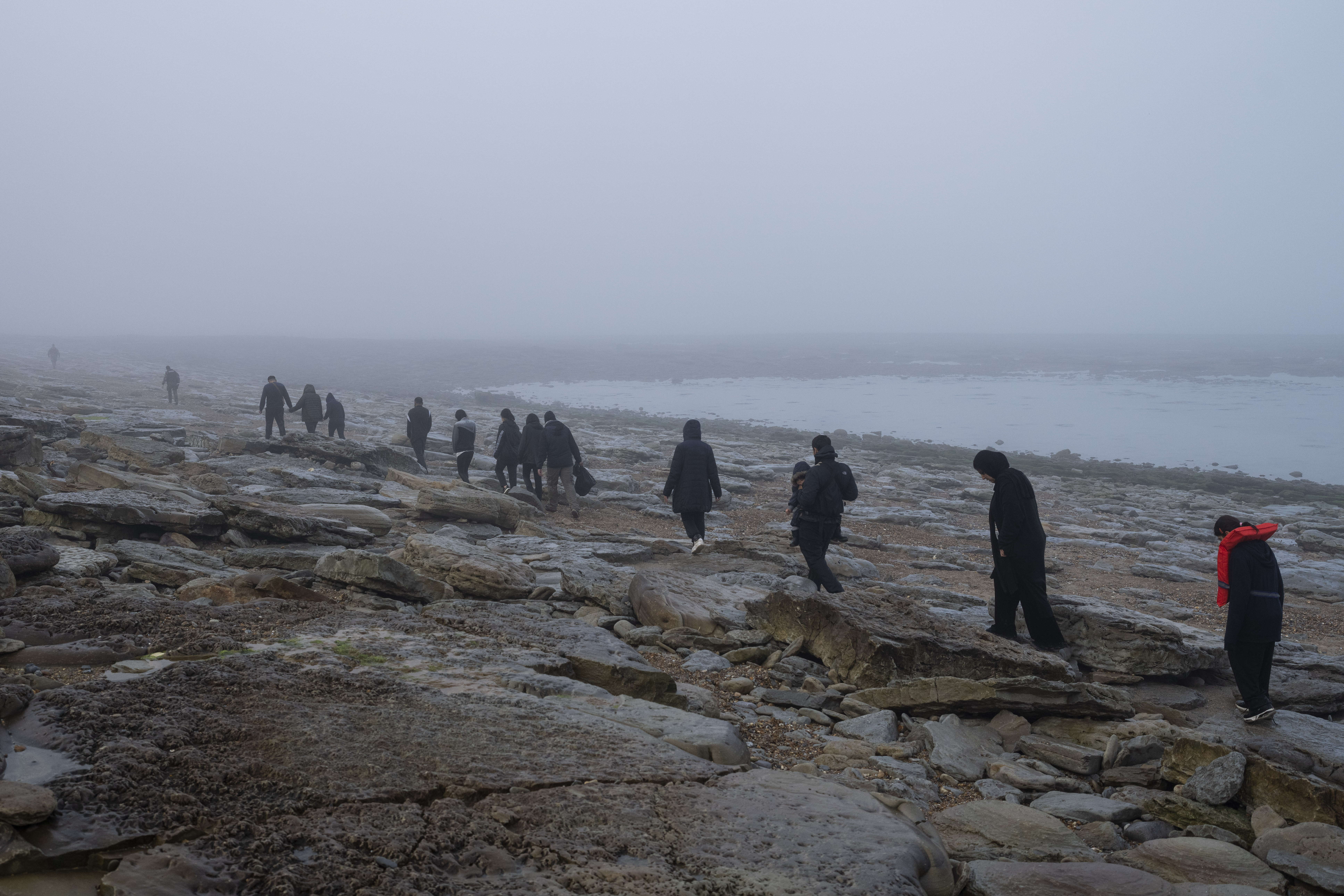 FILE - A group of Kurdish migrants from Iran and Iraq who failed in their attempt to reach the United Kingdom by boat walk back to the town of Ambleteuse, northern France, on Sunday, May 19, 2024, after being discovered by the police. (AP Photo/Bernat Armangue, File)