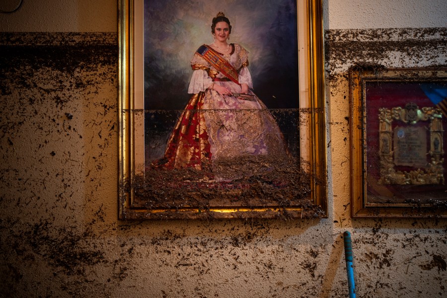 A painting hangs near the water level marker in an area affected by floods in Paiporta, Valencia, Spain, Tuesday, Nov. 5, 2024. (AP Photo/Emilio Morenatti)