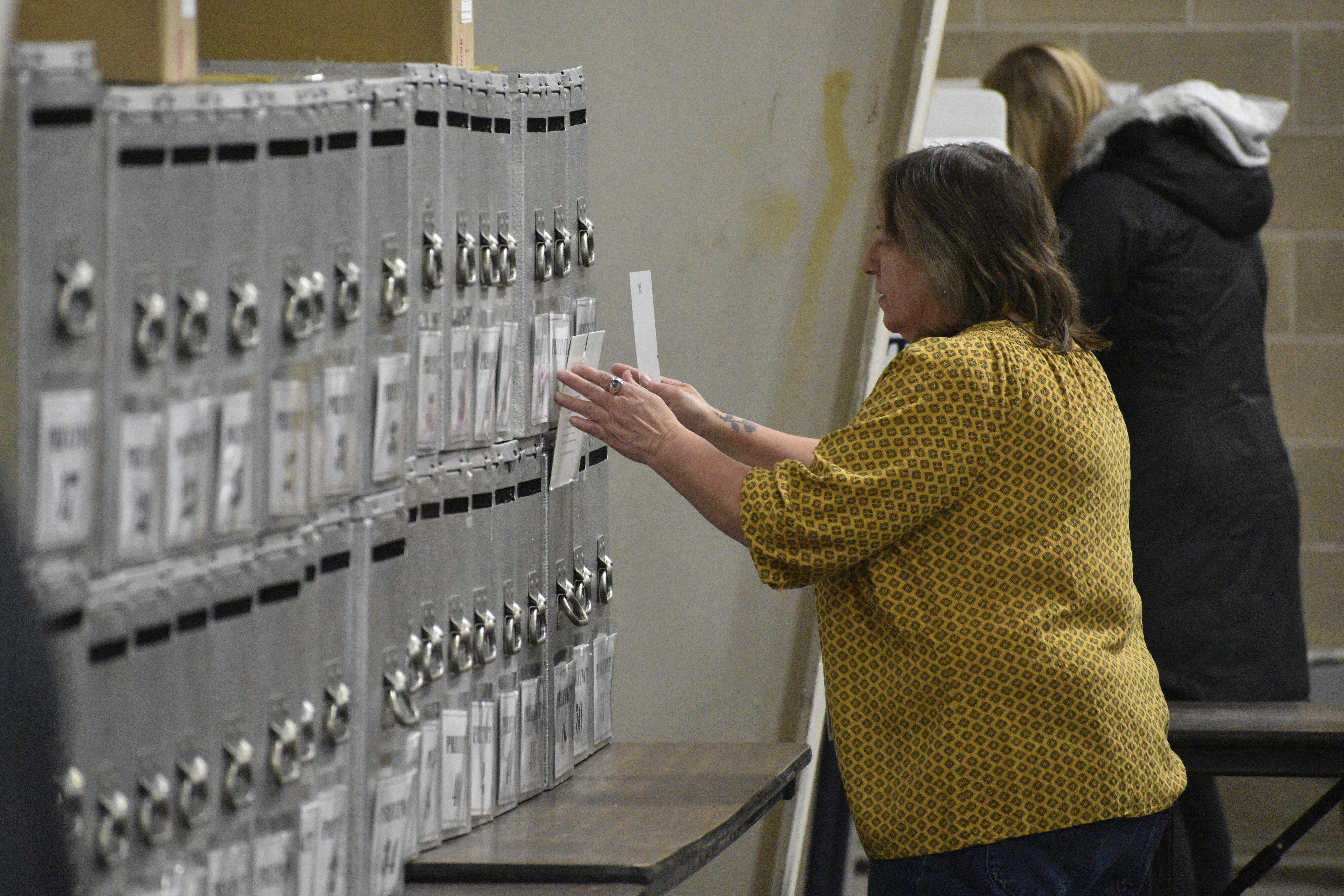 A Yellowstone County election worker places a ballot into a box at MetraPark on Election Day, Tuesday, Nov. 5, 2024, in Billings, Mont. (AP Photo/Matthew Brown)