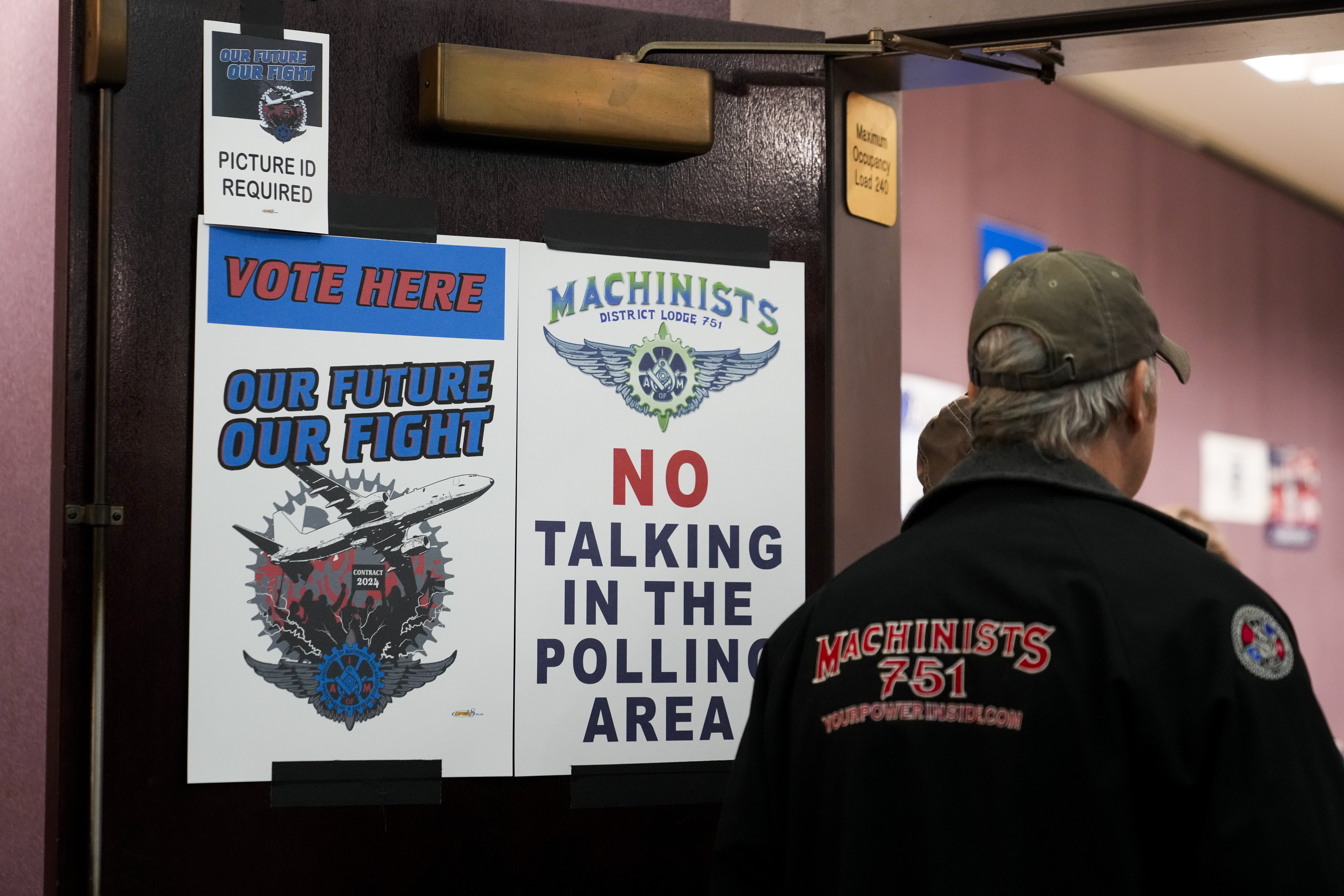 A worker watches as volunteers tally votes on a new contract offer from Boeing, Monday, Nov. 4, 2024, at IAM District 751 Union Hall in Seattle. (AP Photo/Lindsey Wasson)